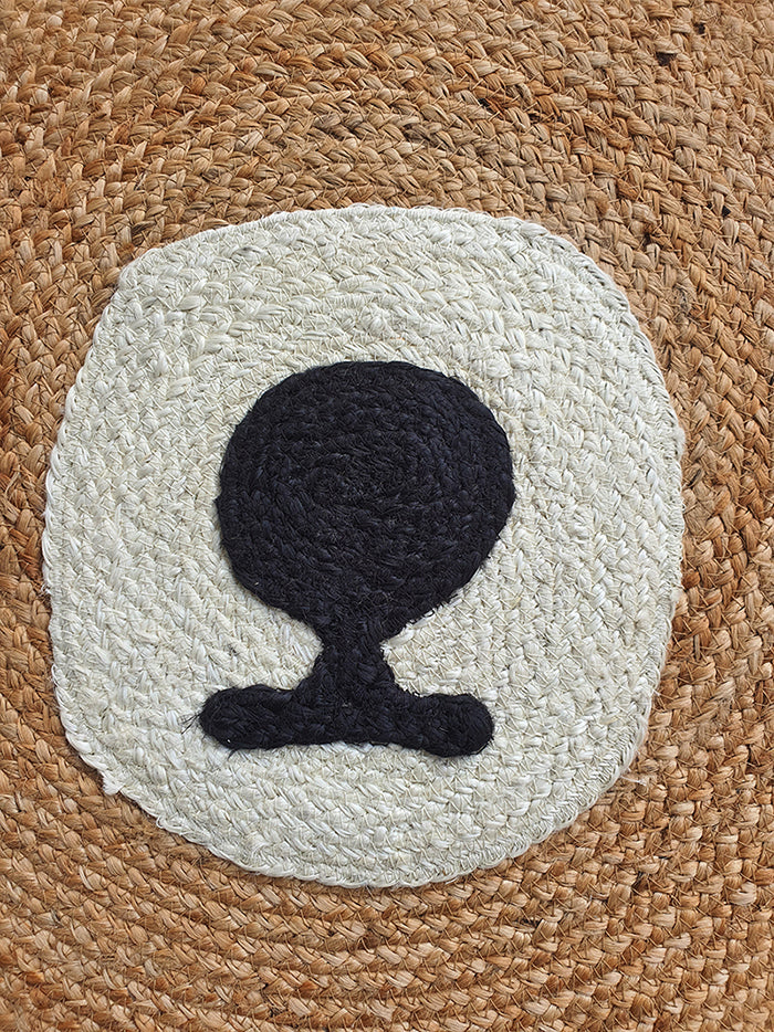 The Amazing Handmade Bear Shape Jute Rug - BR 022 (90cm) by RAMSHA HOME features a woven jute design with a unique bear silhouette, blending off-white and black tones on a textured brown background.