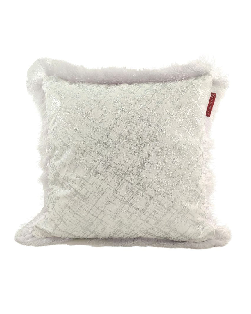 The RAMSHA HOME White & Silver Polyester Cushion CS-122 features a shimmering geometric pattern on light fabric, a fluffy white border, and a small red tag, blending style and comfort for any space.