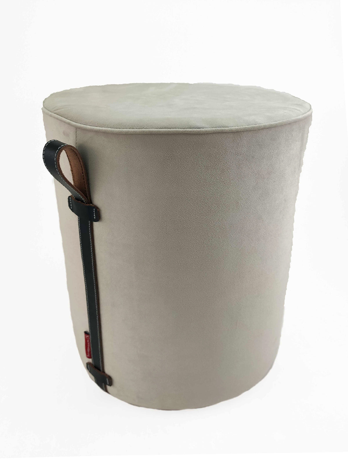 The RAMSHA HOME Leather Pedestal Pouf With Leather Handle is a round, light gray pouf with a soft upholstered surface and a vertical black strap featuring a leather handle on one side, shown against a plain white background.