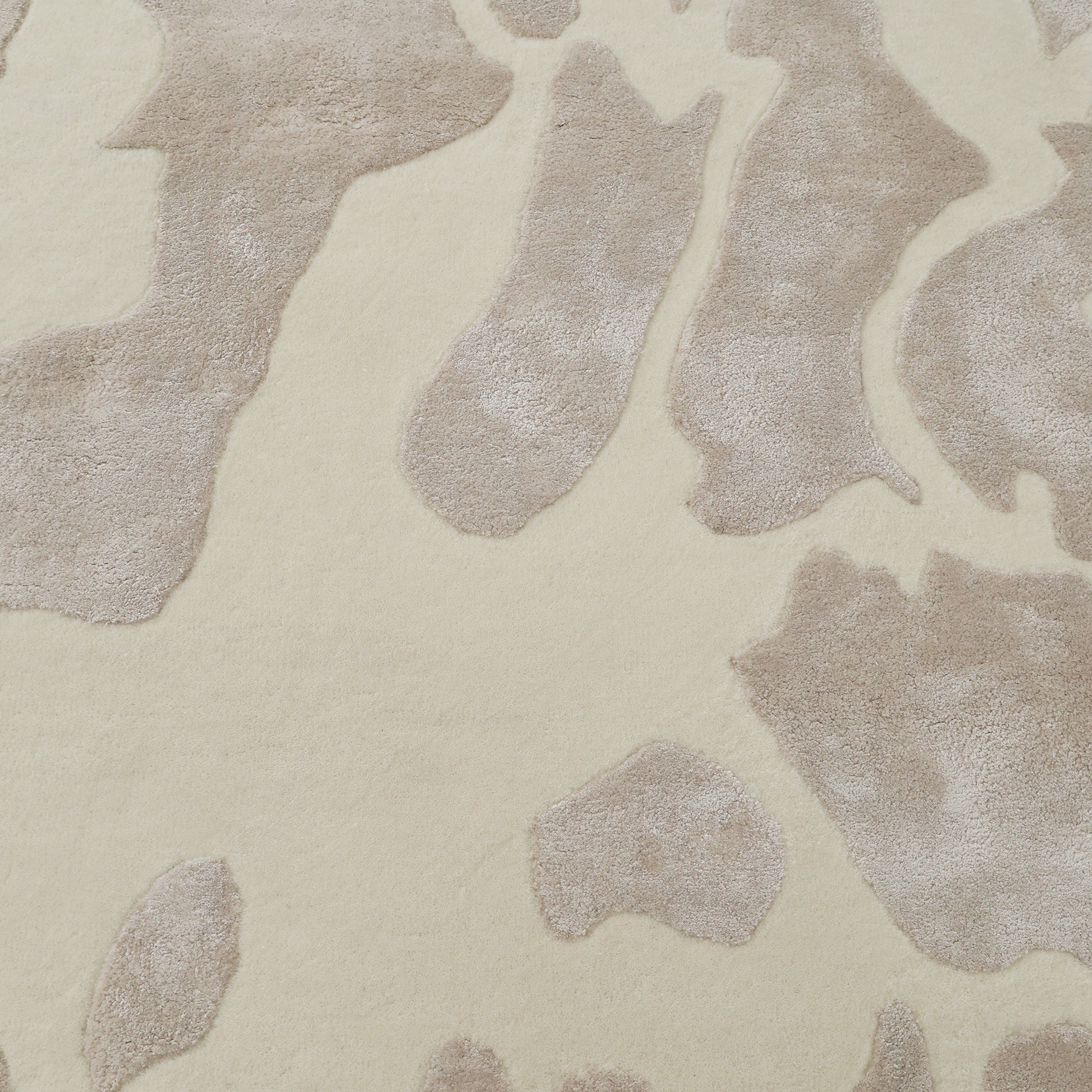 The RAMSHA HOME Multi Color Handmade Area Rug (HTWV-132) features a close-up of its soft, plush handtufted wool viscose with an irregular animal print-inspired pattern—perfect for adding warmth and style to any space.