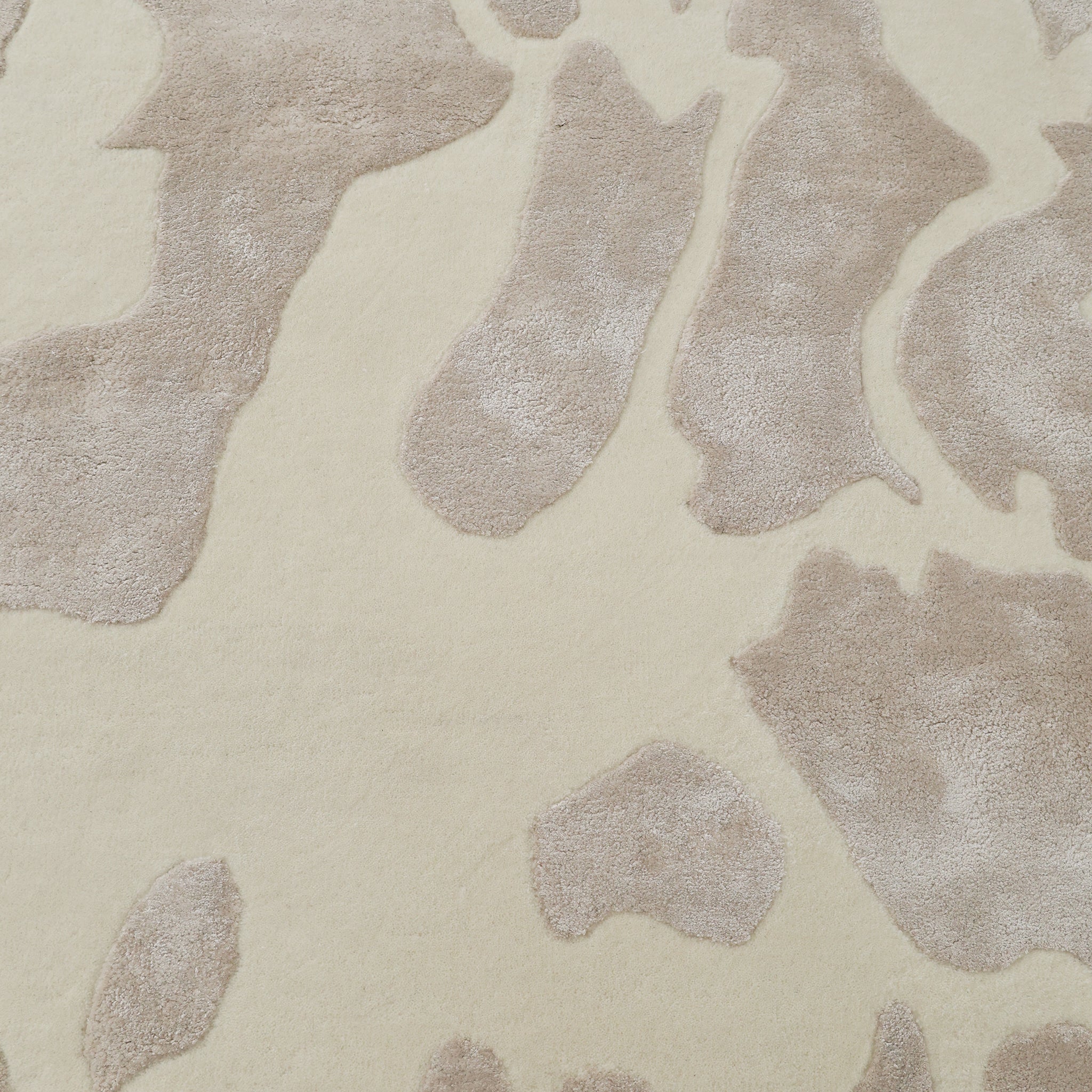 The RAMSHA HOME Multi Color Handmade Area Rug (HTWV-132) features a close-up of its soft, plush handtufted wool viscose with an irregular animal print-inspired pattern—perfect for adding warmth and style to any space.