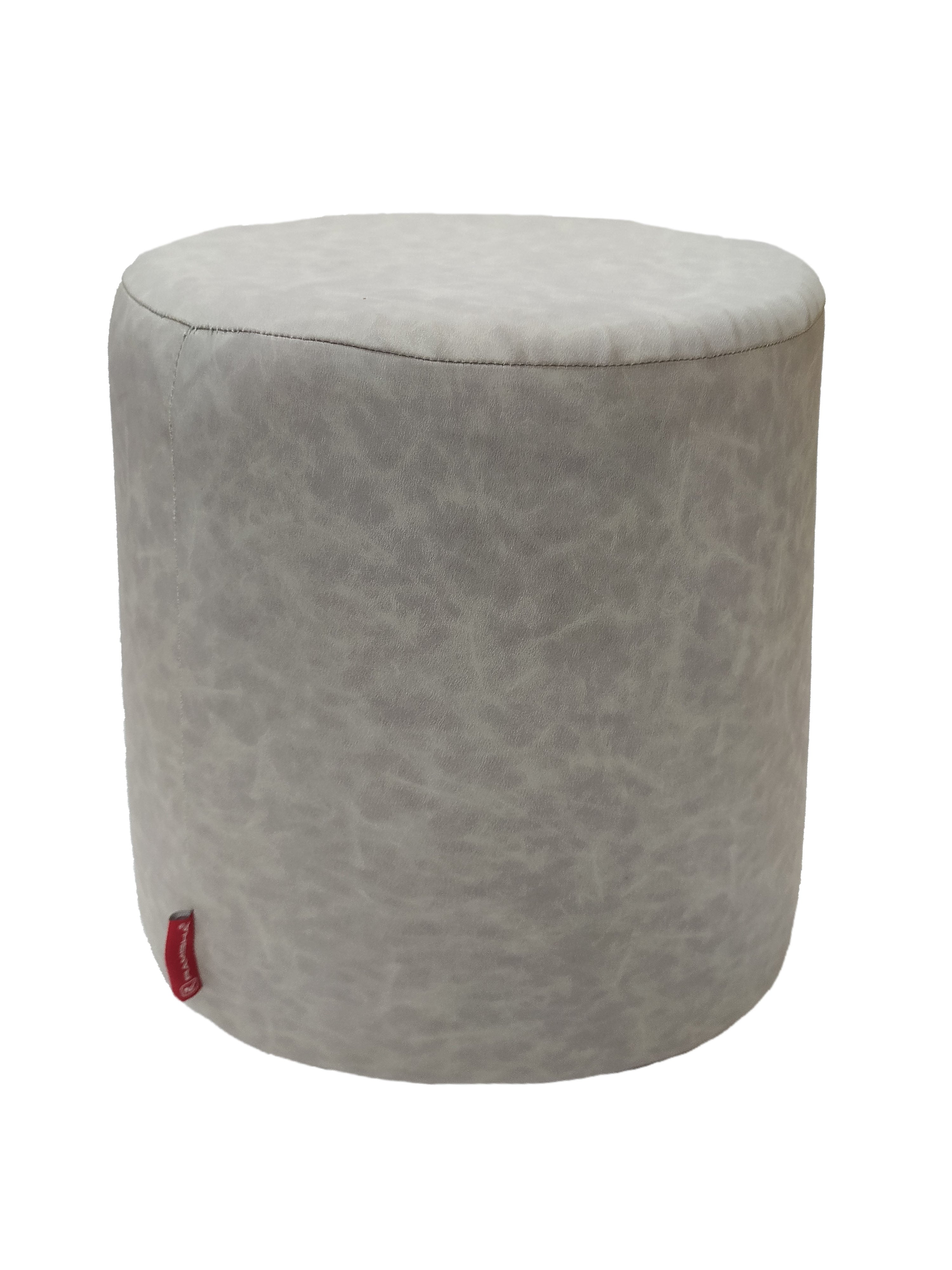 The Leather Cylindrical Pouf by RAMSHA HOME is a round, light grey seat with a soft textured surface and a small red tag on the lower side, shown against a white background.