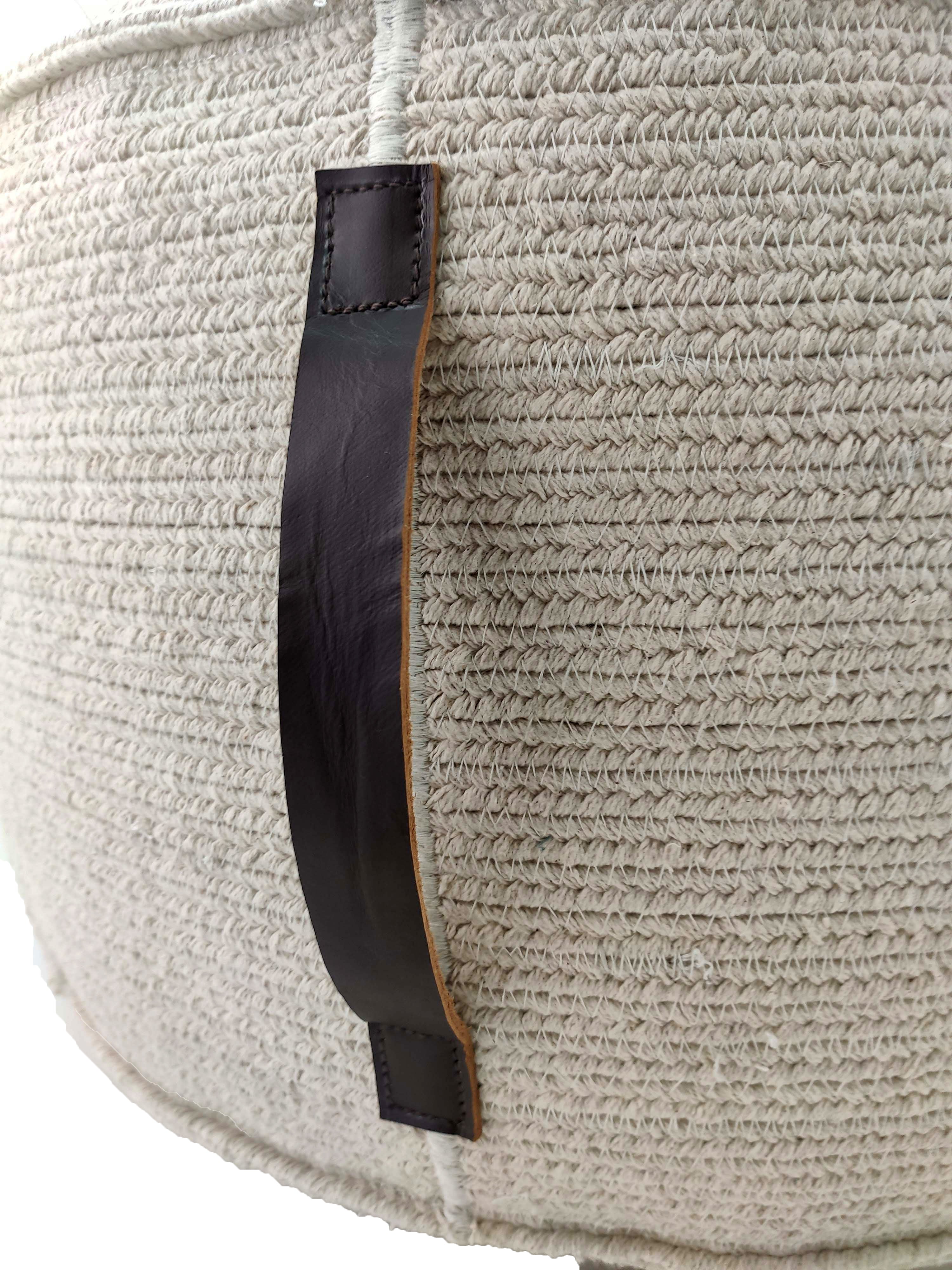 Close-up of the RAMSHA HOME White Cotton Pouf With Leather Handle PF-053, featuring a textured cotton body and a stitched dark brown leather handle—ideal for storing thermocol beans or small items with detailed craftsmanship visible.