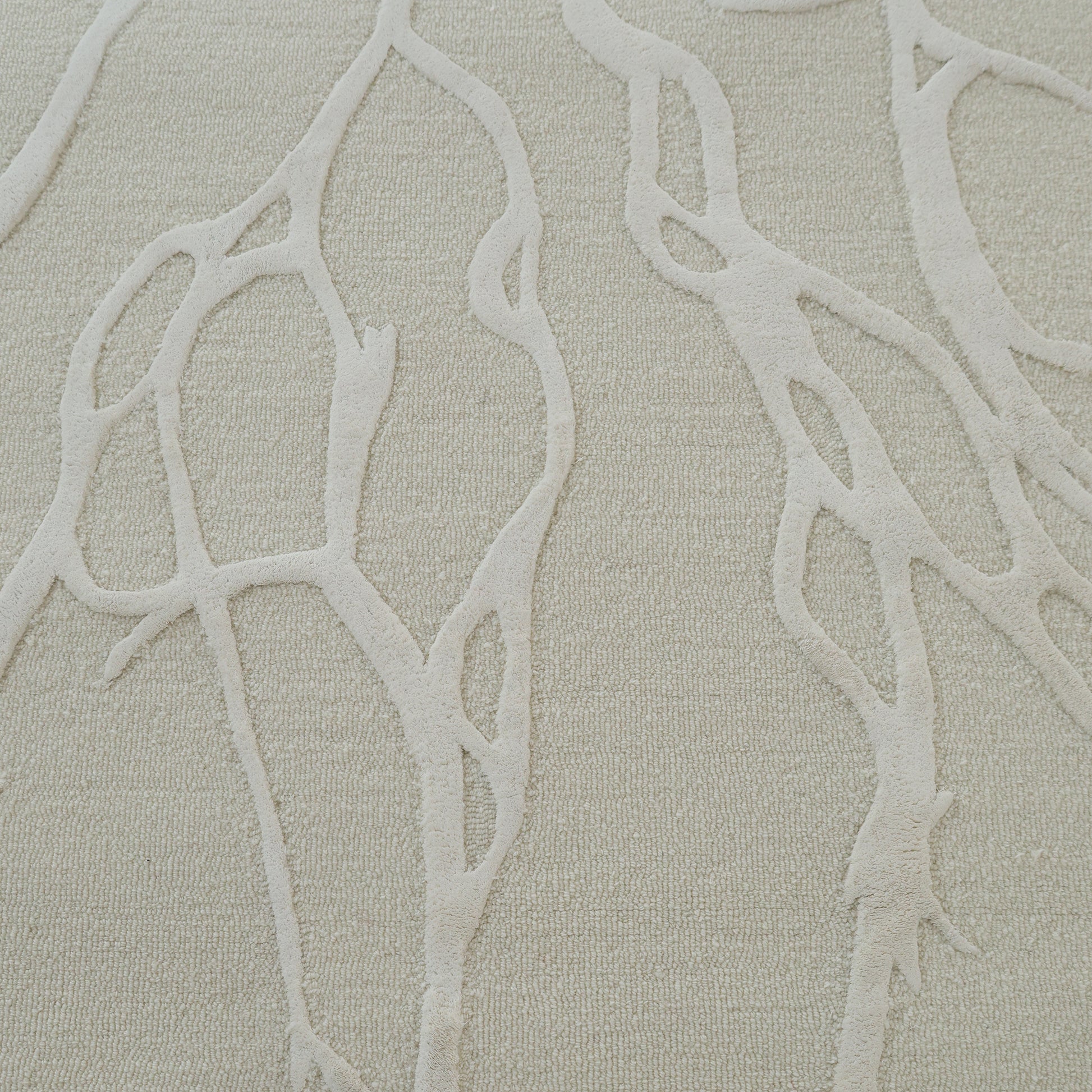 A close-up of the RAMSHA HOME Premium Beige Handmade Carpet HTWV-100 (200×300 cm) displays its textured surface, featuring raised branching abstract lines like tree roots or veins across the neutral beige backdrop.