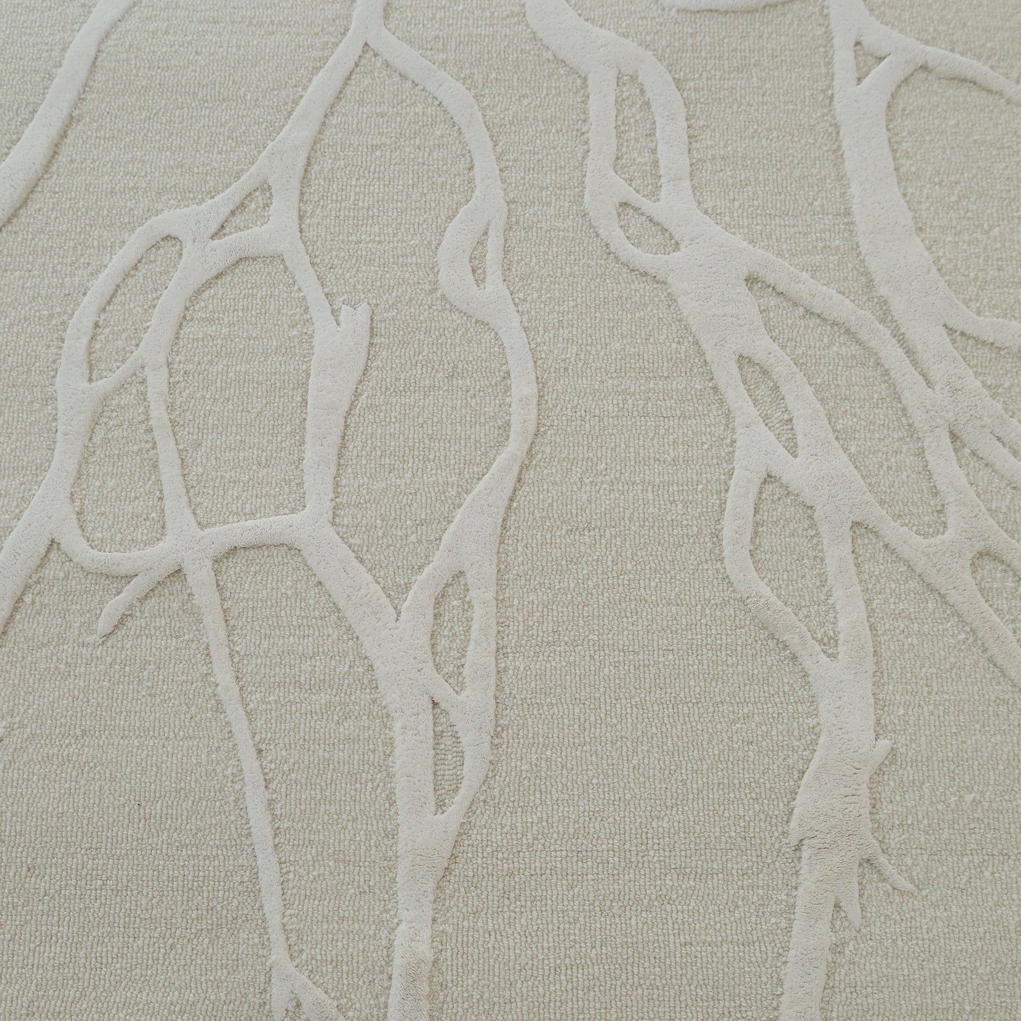 A close-up of the RAMSHA HOME Premium Beige Handmade Carpet HTWV-100 (200×300 cm) displays its textured surface, featuring raised branching abstract lines like tree roots or veins across the neutral beige backdrop.