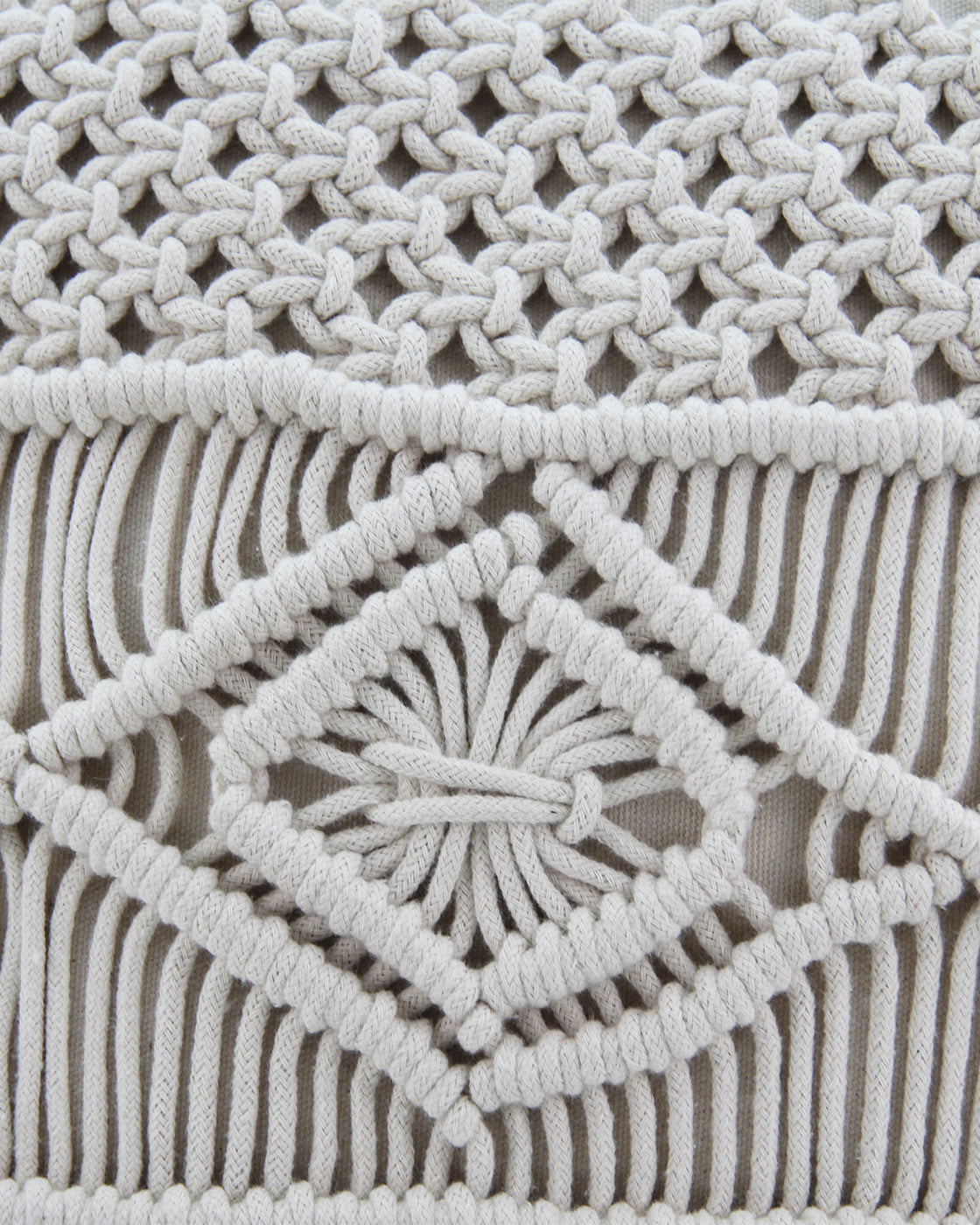 Close-up of the Woven Macrame Cotton Cushion cs-165 by RAMSHA HOME, featuring thick cream cords with diamond shapes and fringes in a geometric design for a luxurious textured accent.