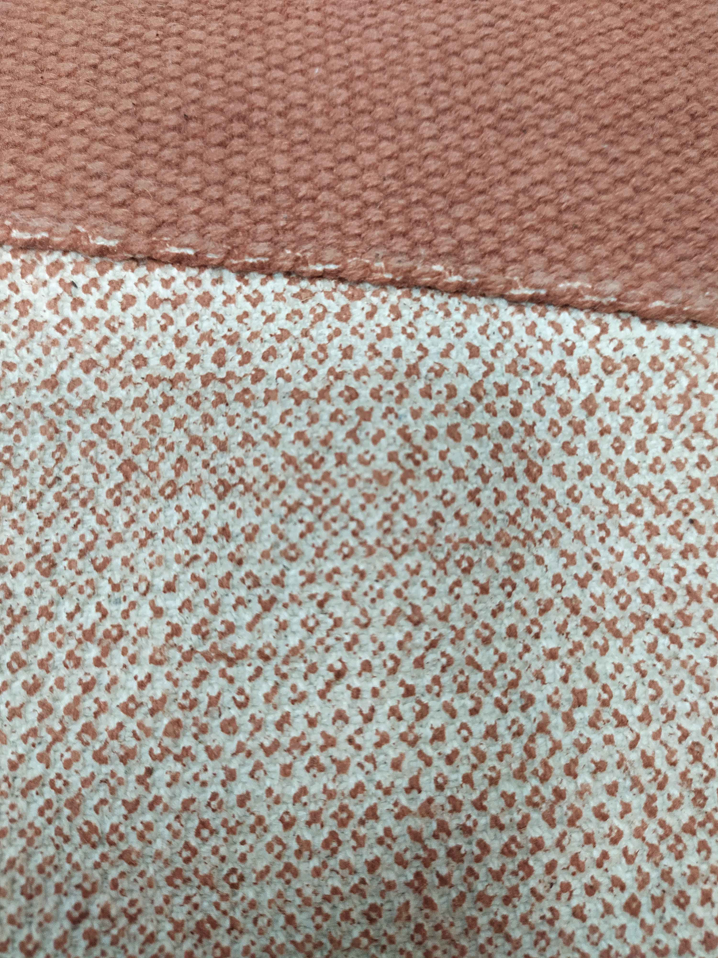 Close-up of RAMSHA HOME's Multi Color Cotton Cushion CS-135: the top shows solid brown, rough-weave fabric; the bottom displays off-white cotton with dense small brown dots—perfect for stylish, textured comfort.