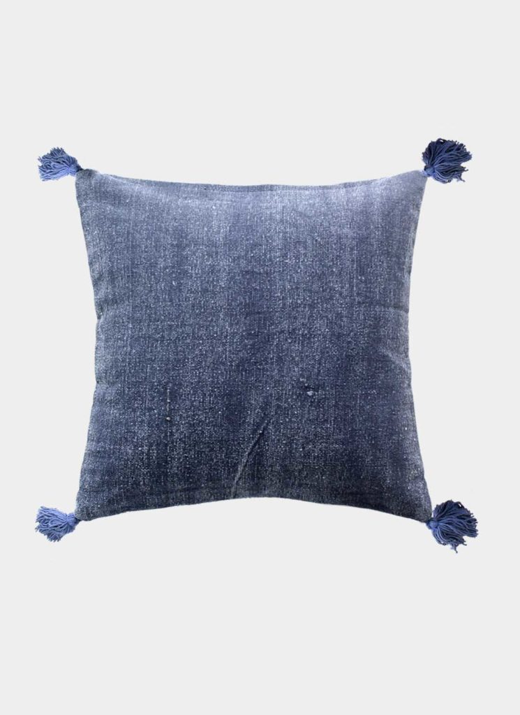 The RAMSHA HOME Polyester Geometry Cushion With Tassel cs-237 features a blue velvet texture and corner tassels, set against a white background—a stylish, modern décor piece for contemporary spaces.