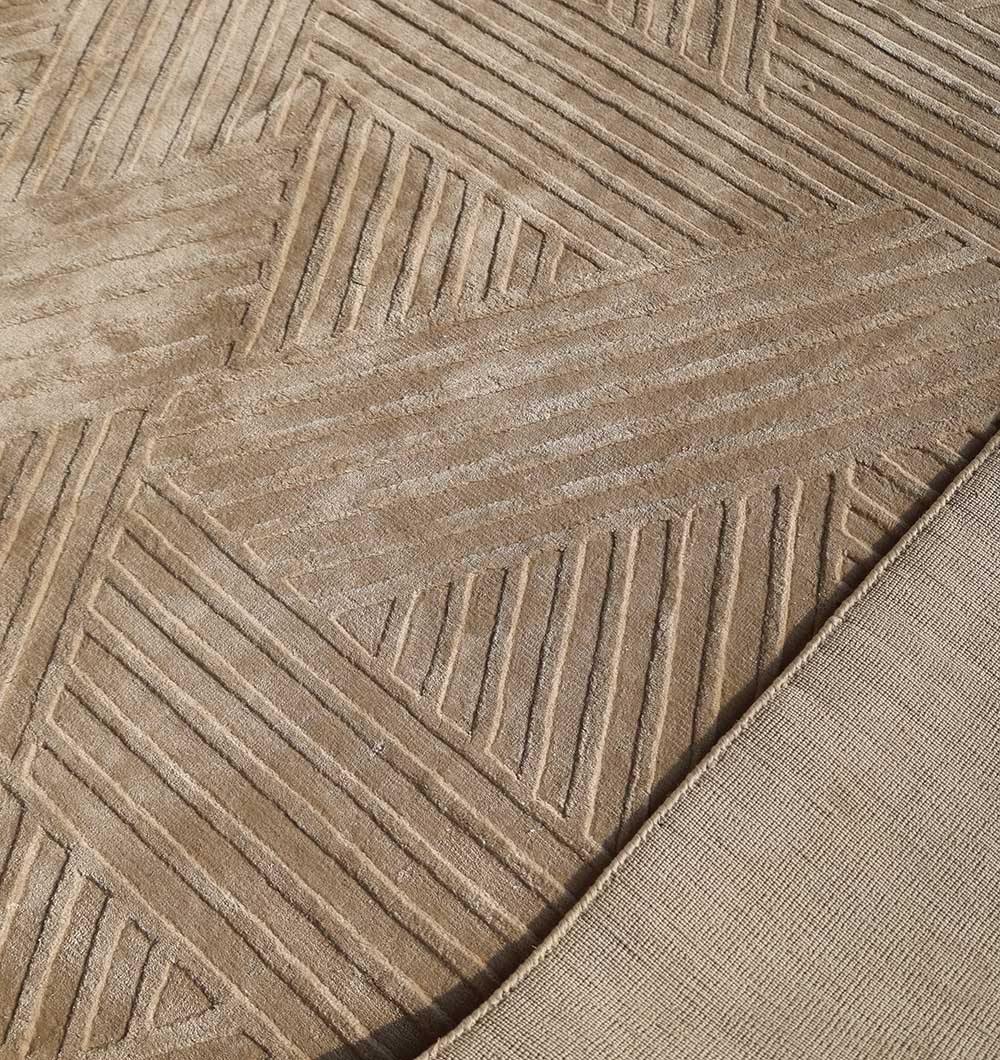 Close-up of the RAMSHA HOME Textured Geometric Home Decor Handmade Area Rug - LKH-06 in beige, showcasing its intersecting line pattern; a corner is folded to display the plain underside.