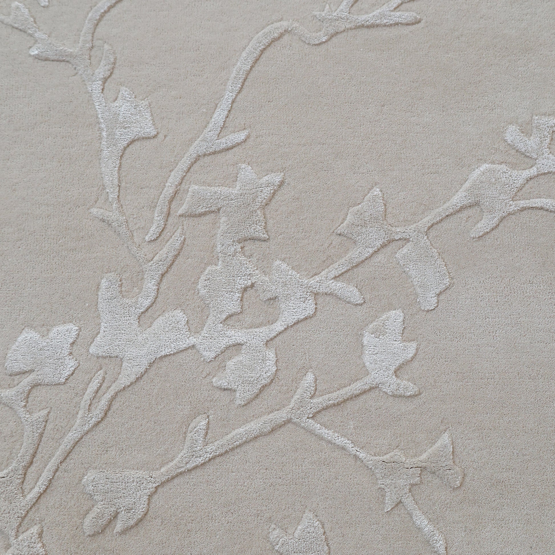The RAMSHA HOME Handmade Beige Color Decor Rug-HTWV 115 features a subtle raised vine pattern in lighter tones, offering an elegant and neutral design ideal for anchoring any room’s décor.
