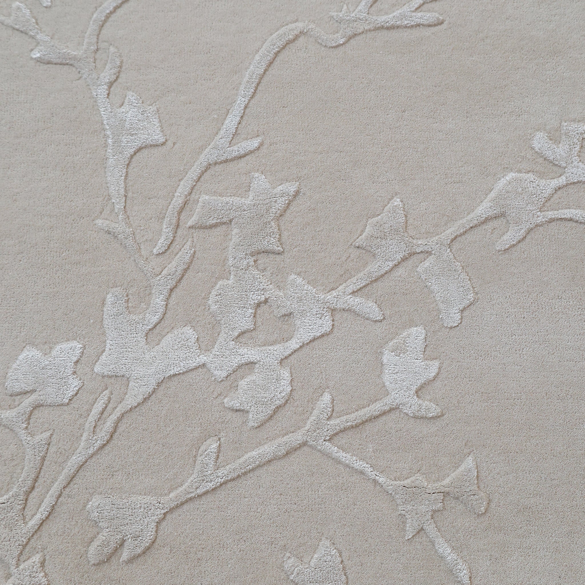 The RAMSHA HOME Handmade Beige Color Decor Rug-HTWV 115 features a subtle raised vine pattern in lighter tones, offering an elegant and neutral design ideal for anchoring any room’s décor.
