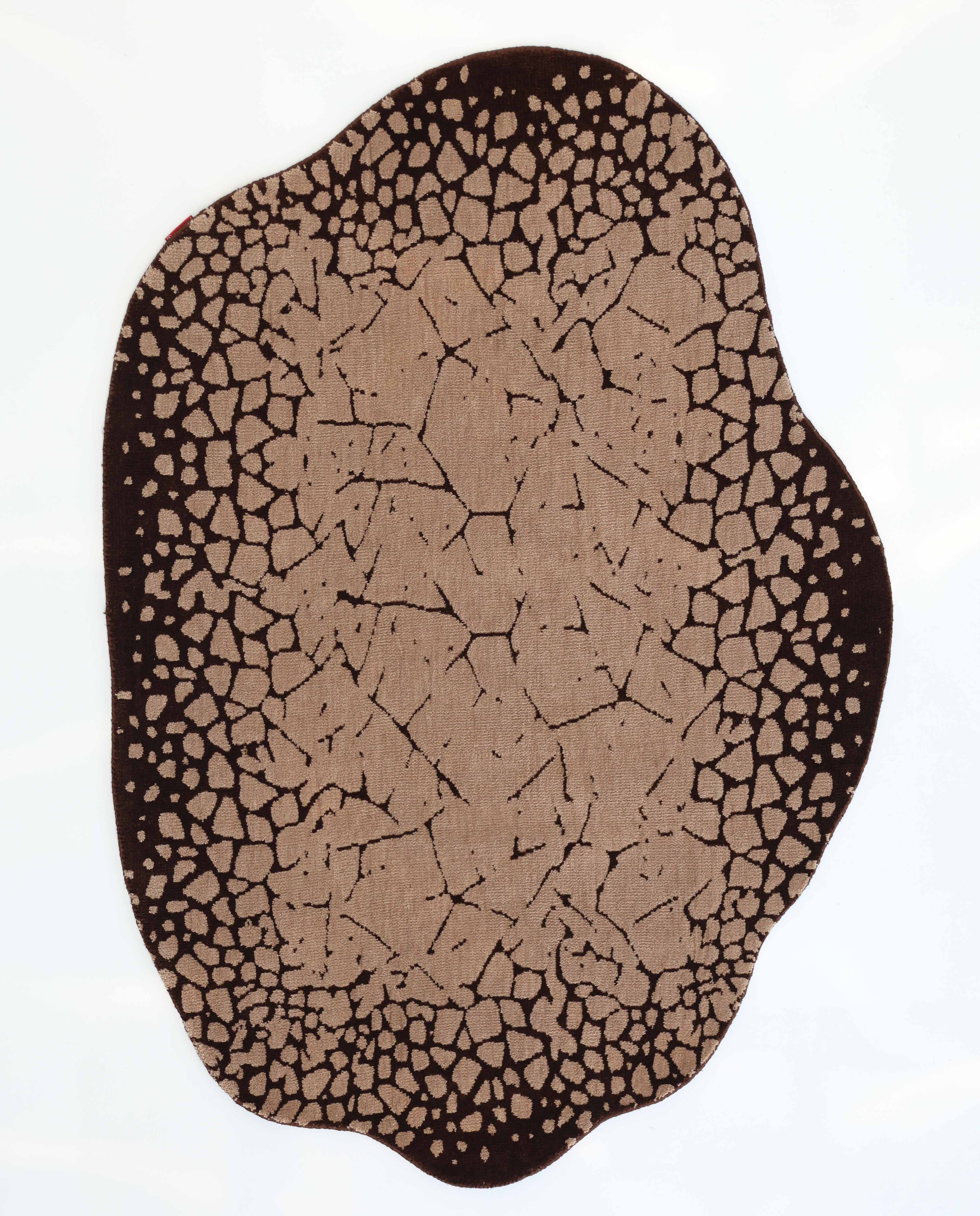 The RAMSHA HOME Terrain Echo Abstract Rug Shaped Rug CMN 118 features an irregular shape and earth-inspired pattern in brown and tan, with wavy edges, resembling cracked soil across a white background.