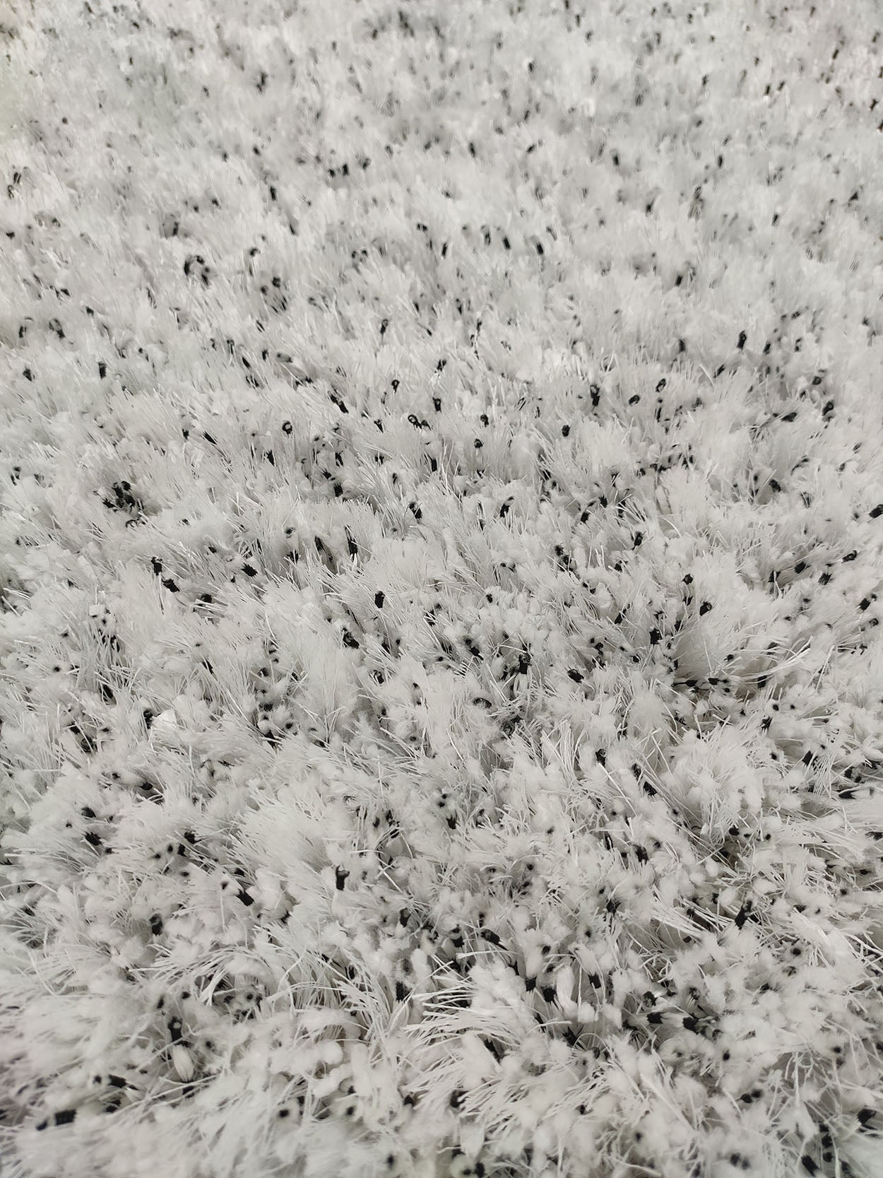 RAMSHA HOME's White & Black Color Soft Shaggy Rug for Living Room (DPB 01) features a white surface with black threads, offering a modern, textured look and cozy softness for any space.