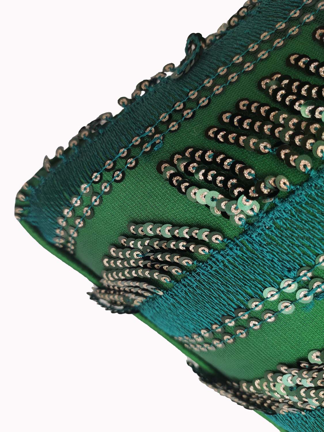 Close-up of the RAMSHA HOME Modern Polyester Cushion Cover, showcasing green fabric with teal embroidery and shiny silver sequins in wavy patterns.