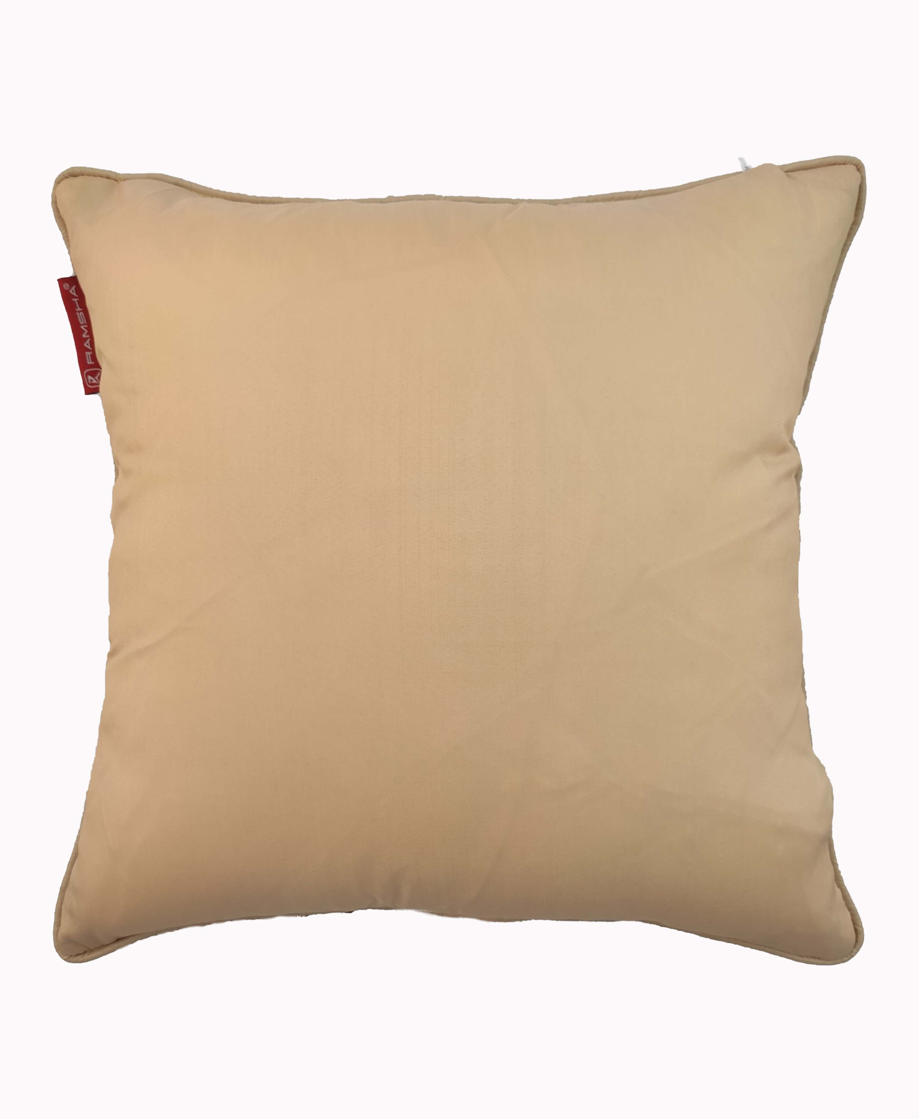 The RAMSHA HOME Polyester Sequine Cushion Cover features a plain, square beige design with a small red fabric tag on the left edge—ideal as living room decor thanks to its versatile style and durable polyester material.