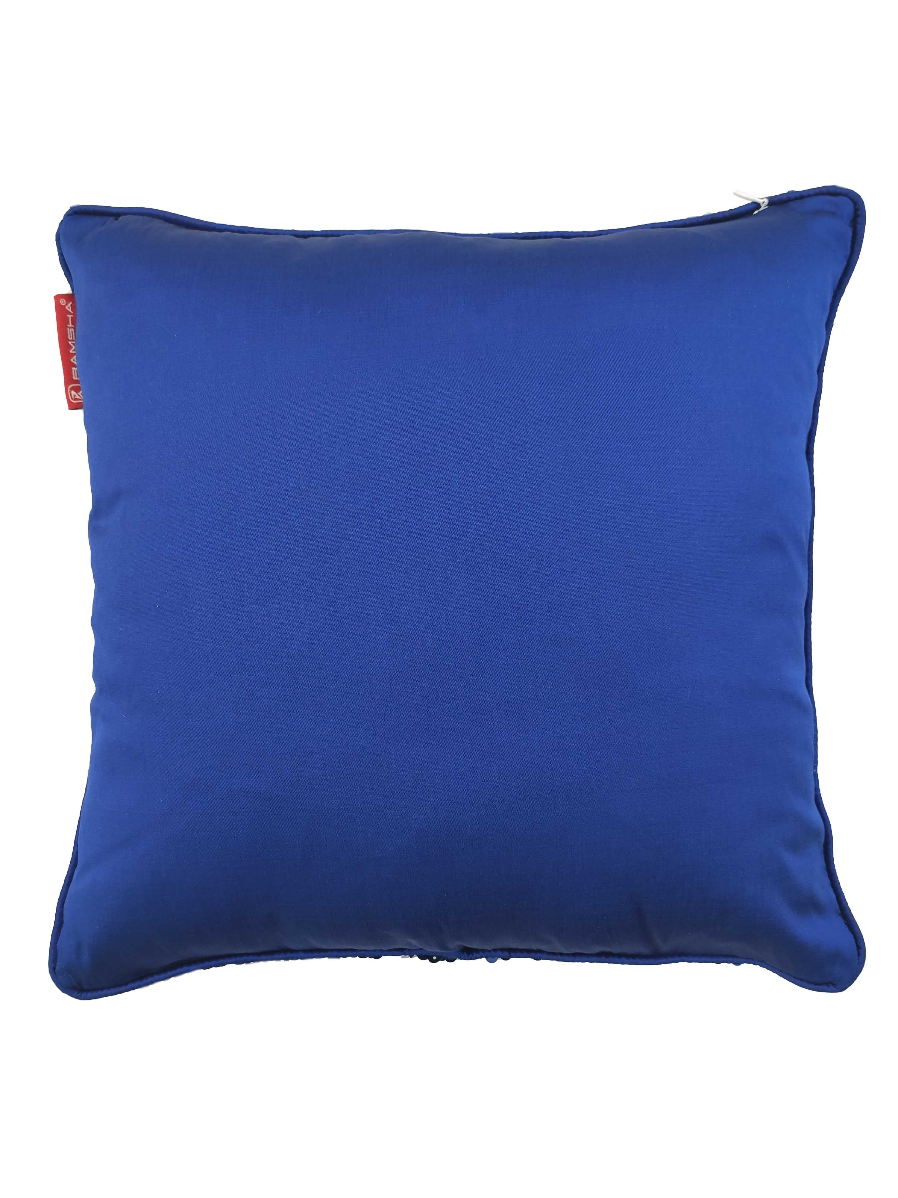 The RAMSHA HOME Polyester Sequine Cushion Cover features a square blue design with a smooth finish, top-edge zipper, and a red tag on the side—ideal for stylish living room decor. Photographed against a white background.