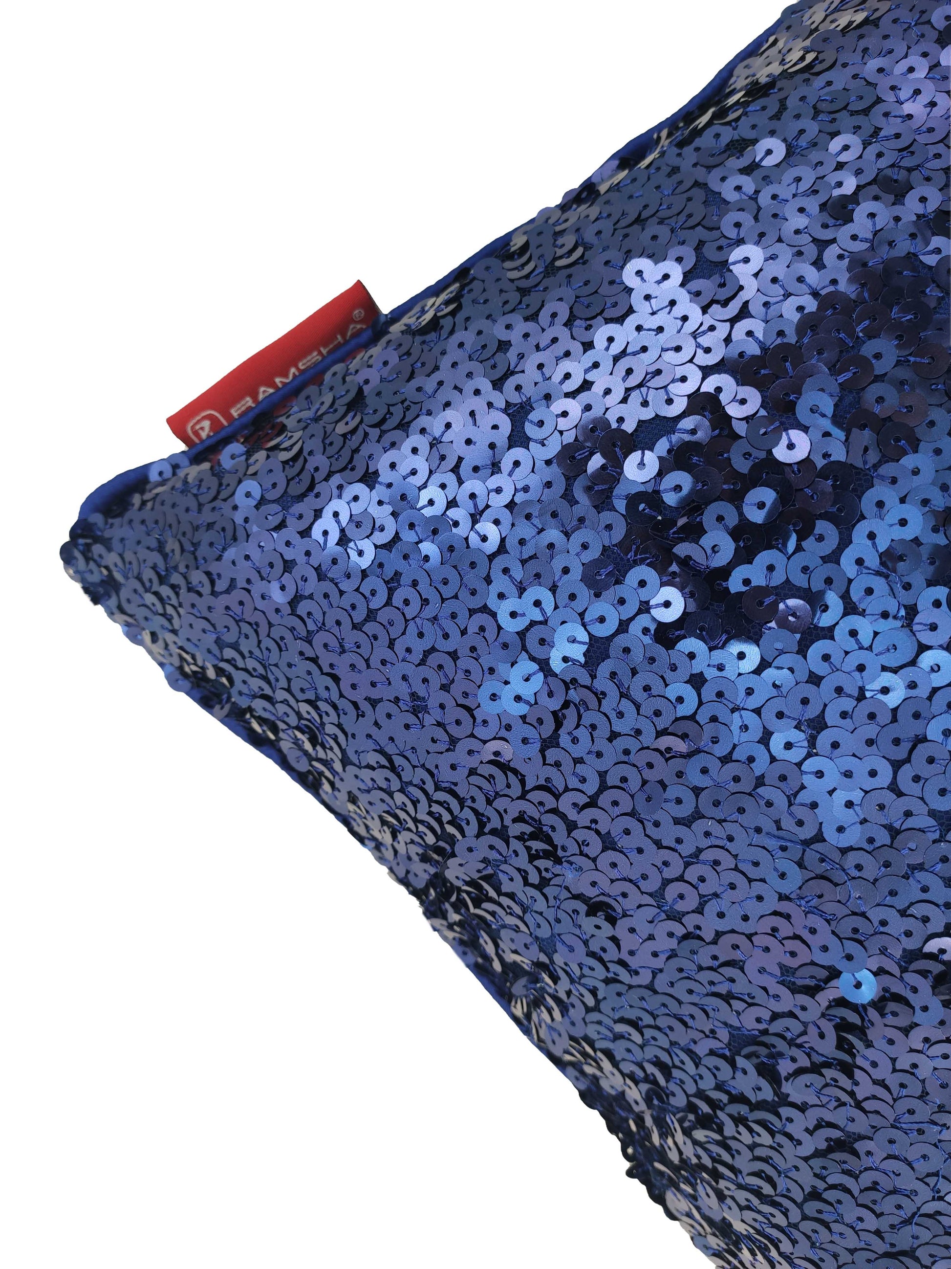 Close-up of RAMSHA HOME Polyester Sequine Cushion Cover in shiny blue, featuring a red tag at the top left corner—perfect for adding sparkle to your home decor against a white background.
