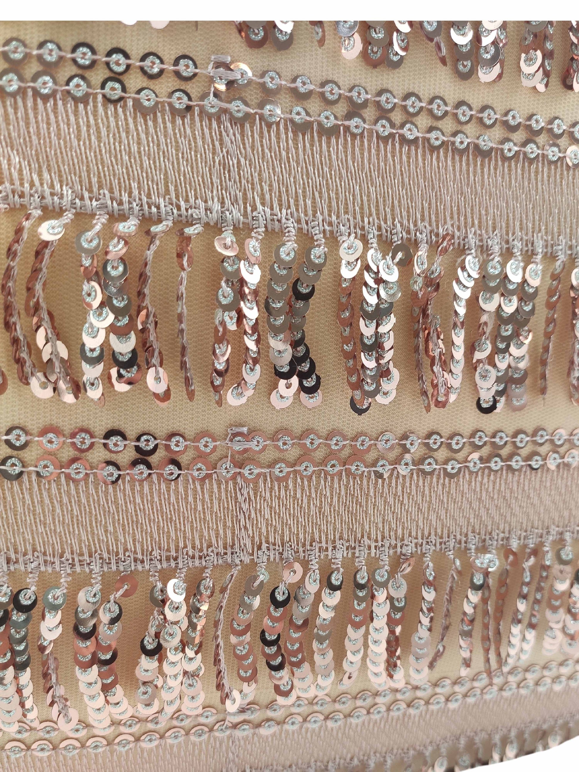 Close-up of the RAMSHA HOME Modern Polyester Cushion Cover, showcasing shiny silver sequins and fringe on a light beige mesh for a decorative, textured look.
