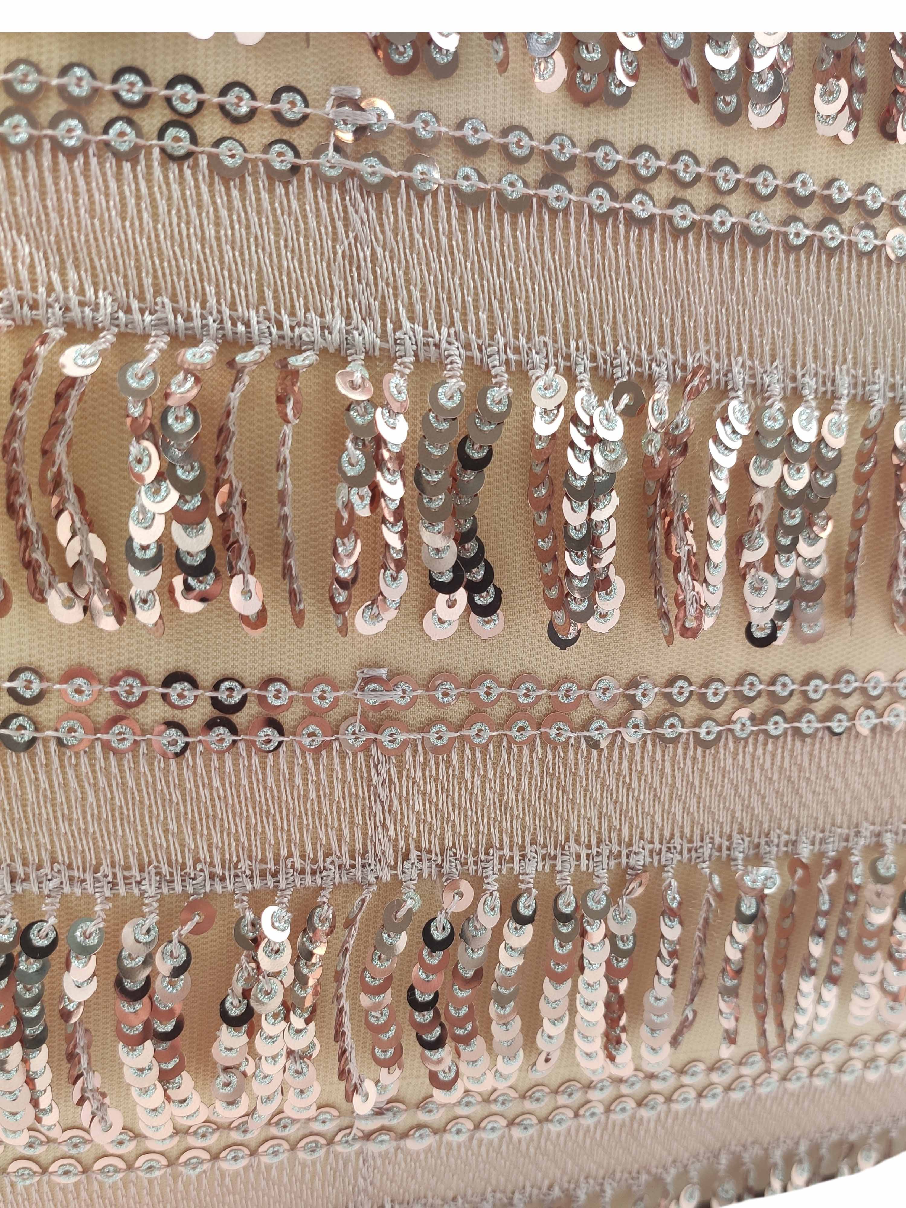 Close-up of the RAMSHA HOME Modern Polyester Cushion Cover, showcasing shiny silver sequins and fringe on a light beige mesh for a decorative, textured look.