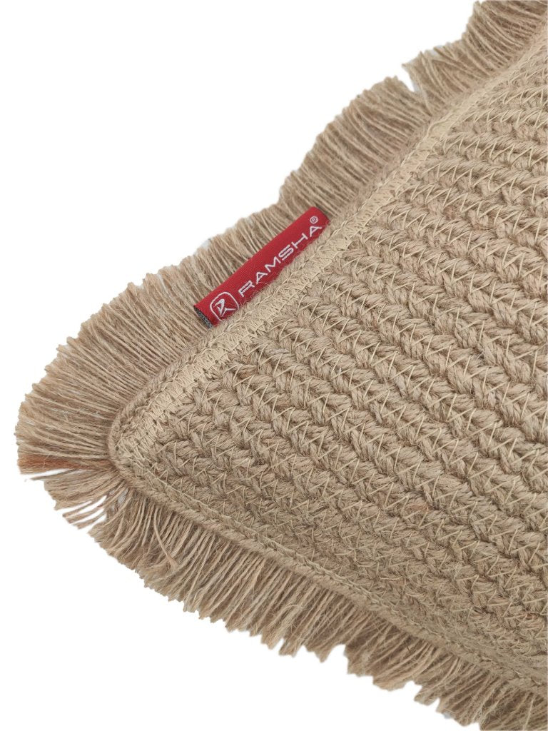 Close-up of the Natural Color Jute & Cotton Cushion With Filler CS-030 featuring fringed edges and a red RAMSHA HOME fabric tag on one side.