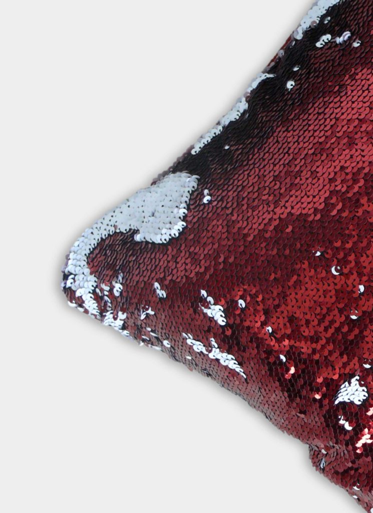 A close-up of the RAMSHA HOME Home Decor Cushion Cover shows reversible red and silver sequins, partially flipped on a light gray background, adding playful style to your living room or home decor.