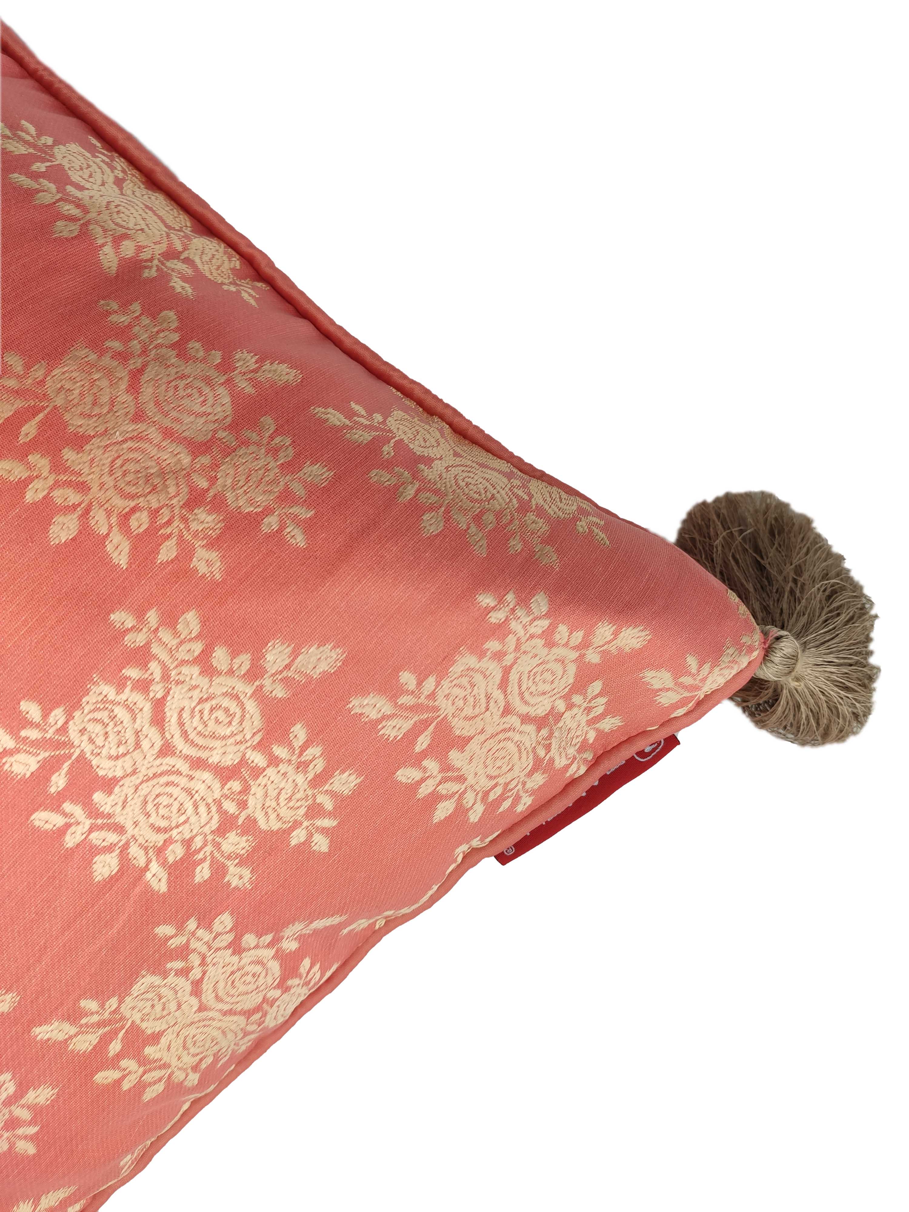 Close-up of RAMSHA HOME's Light Pink Cushion Cover CS-043, featuring an embroidered cream floral pattern and a brown corner tassel—an elegant upgrade for your home décor. Shown against a white background.