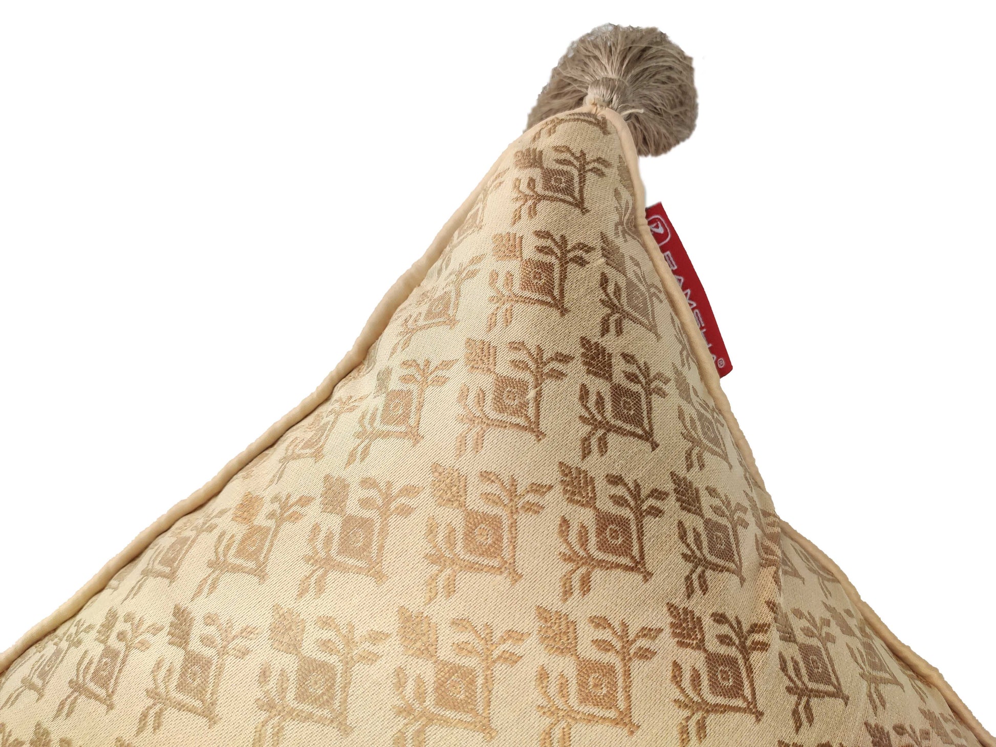 A close-up of RAMSHA HOME’s Modern Polyester Cushion Cover CS-044 in beige with a brown floral pattern, tassel tip, and red fabric tag—ideal for contemporary decor—shown against a white background.