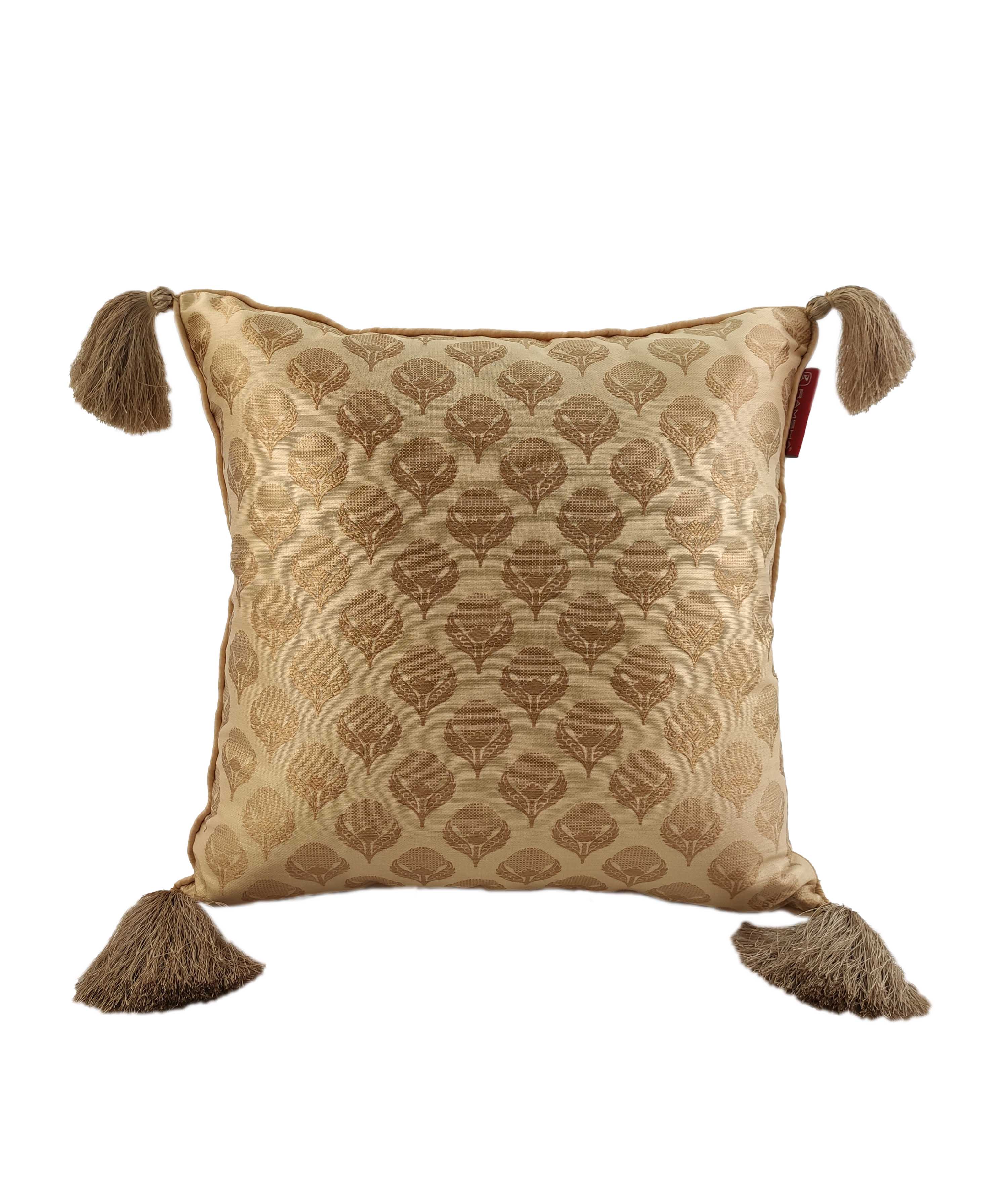 The RAMSHA HOME Gold Color Cushion Cover With Tassel CS-045 features a stylized leaf design, subtle sheen, golden beige tassels, and a small red tag—perfect for stylish home decor.