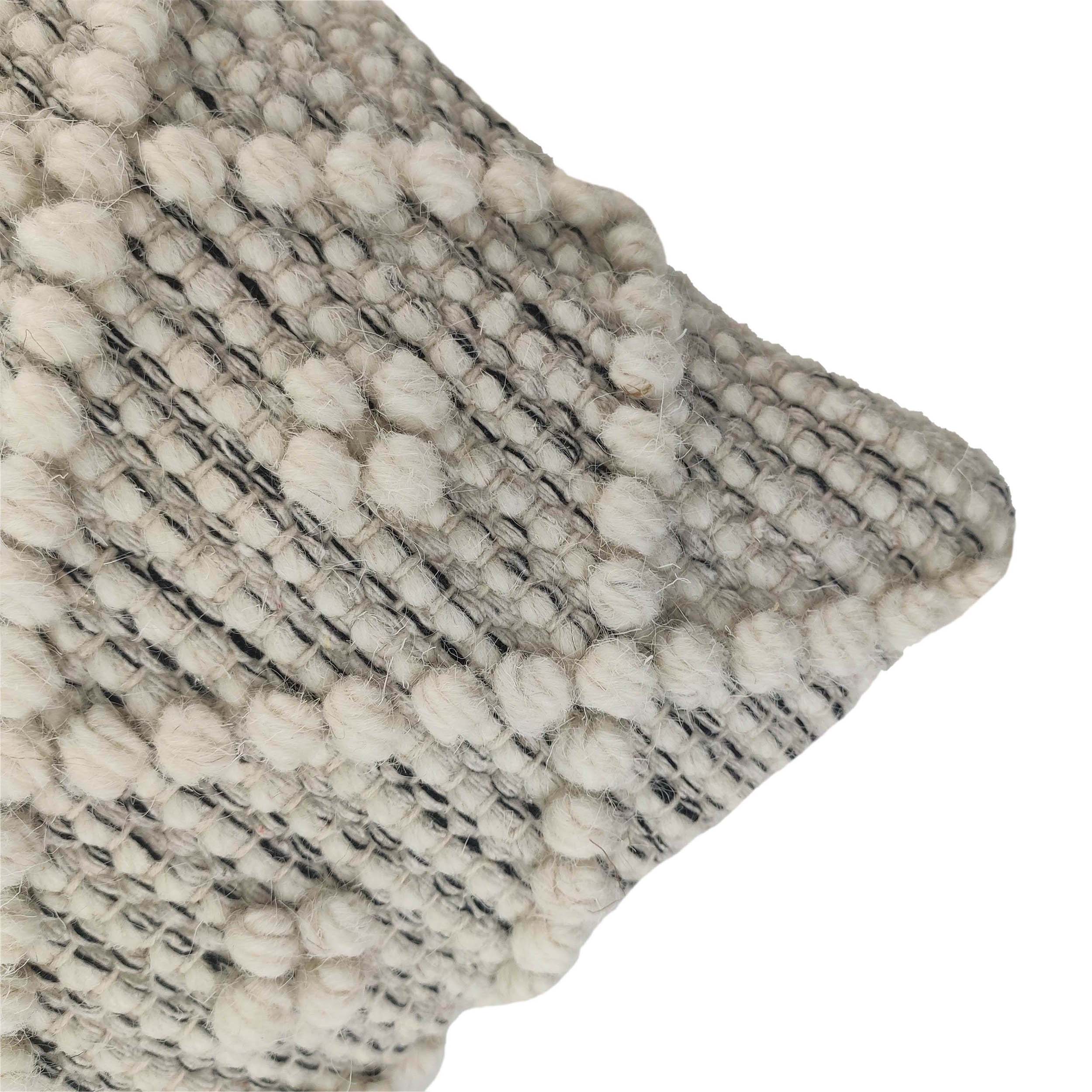 Close-up of RAMSHA HOME’s Woven Cushion With Filler CS-048: cream-colored, textured yarn forms round patterns on a gray base. Ideal for living rooms, the cushion is photographed against a white background.