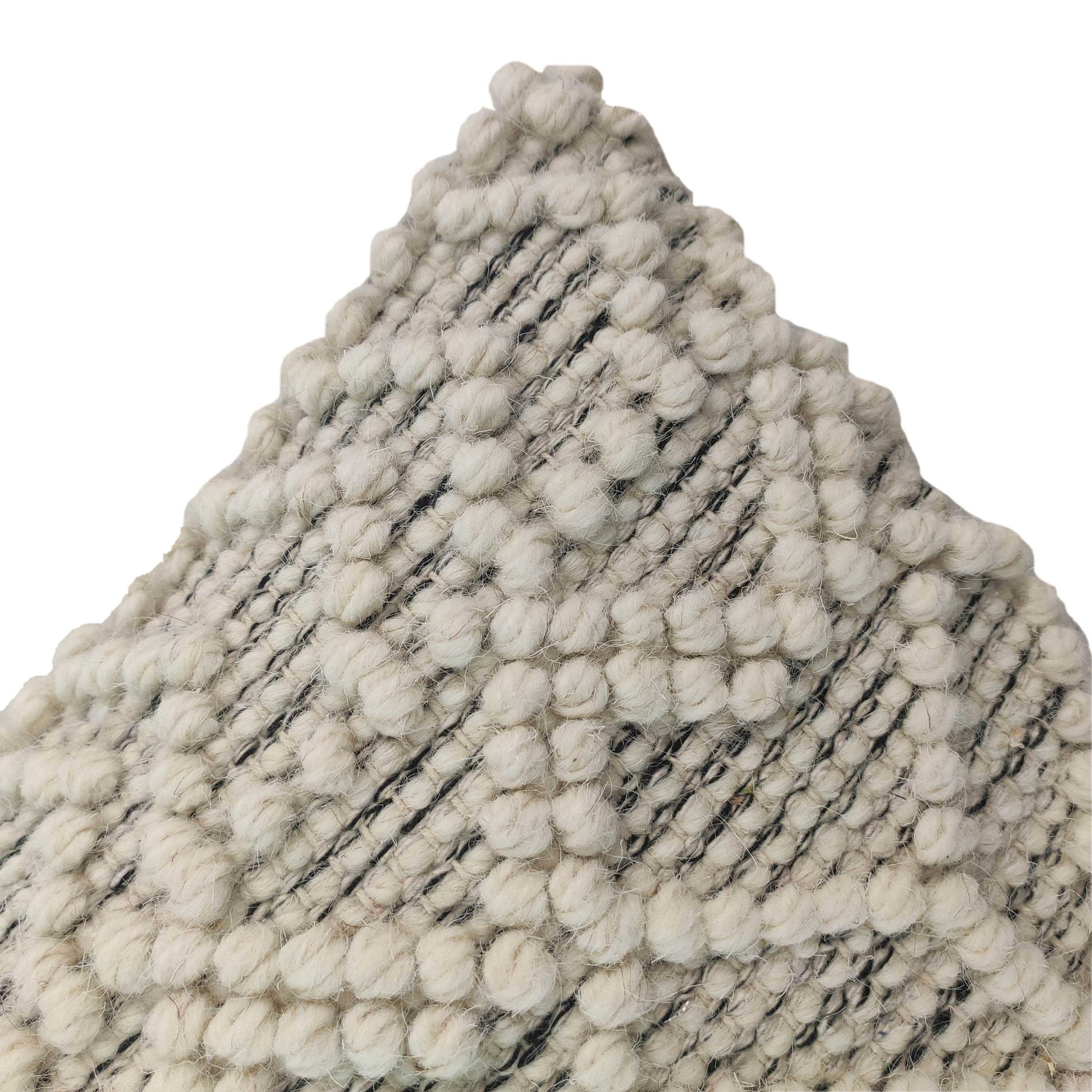 Close-up of RAMSHA HOME's Cushion With Filler Natural & Black Color CS-051, featuring textured ivory fabric with raised geometric bumps and a triangular cut—ideal for enhancing comfort in your interior design.