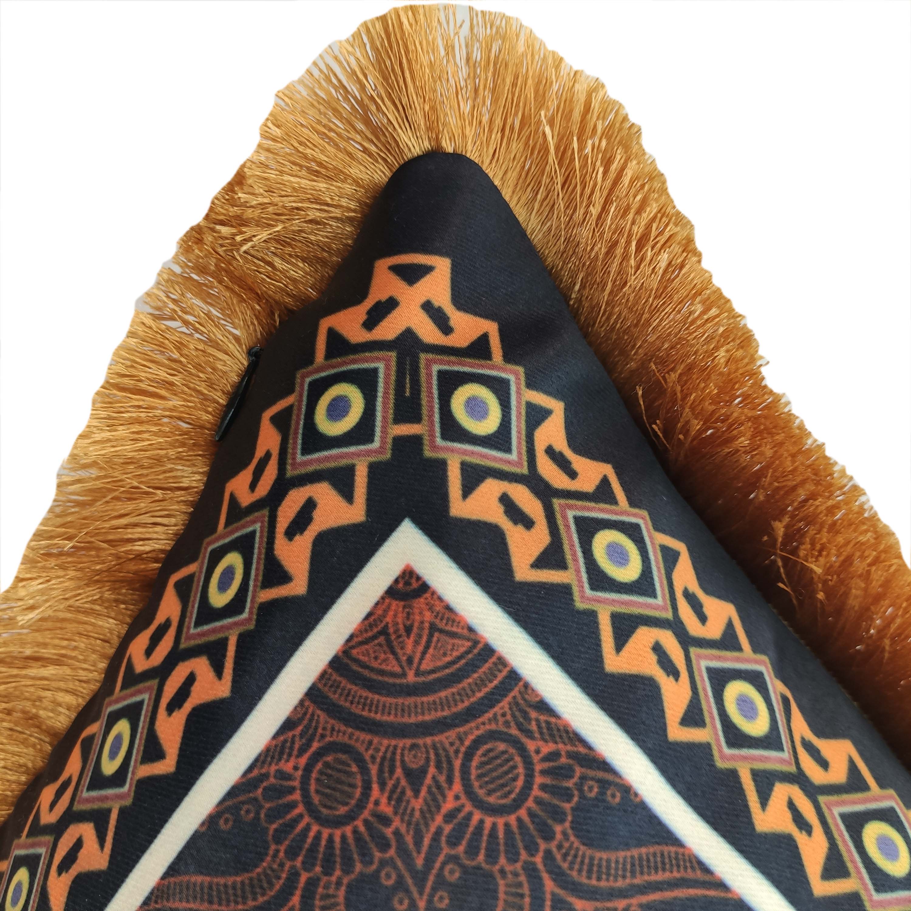 Close-up of RAMSHA HOME's Multi Color Printed Cushion With Filler CS-052, featuring a geometric orange and black pattern with golden-yellow fringe and an intricate mandala design on white. Filler included for added comfort.