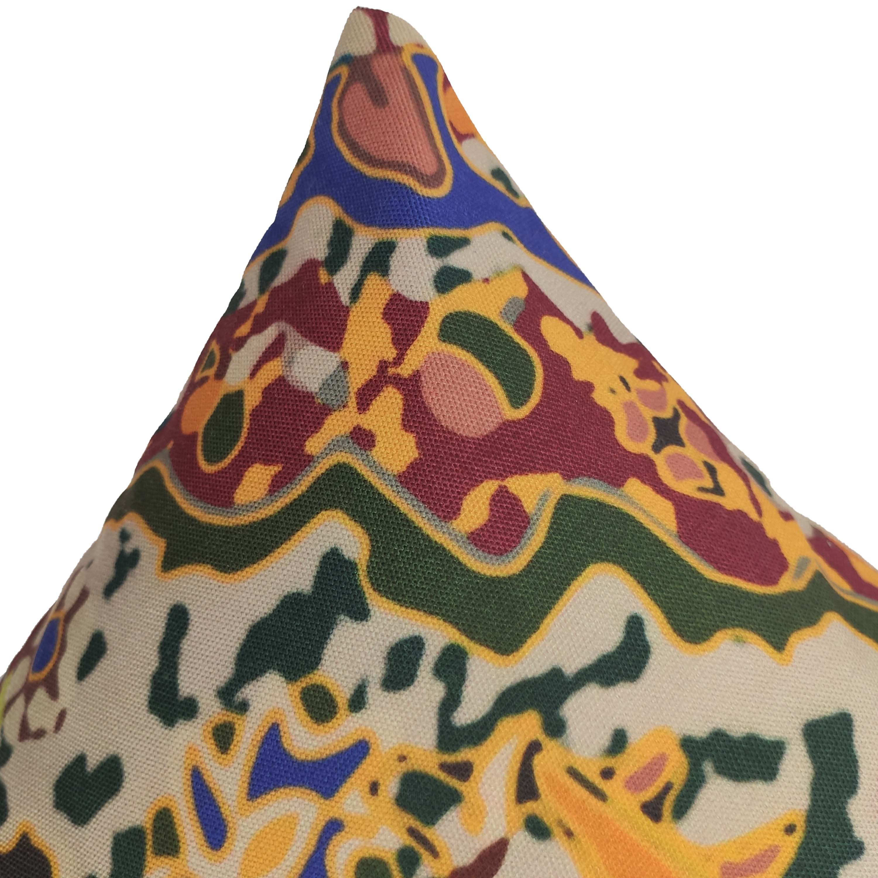 A close-up of the RAMSHA HOME Multi Color Cushion With Filler CS-089 shows its abstract green, yellow, red, and blue shapes on a beige polyester cover. This stylish cushion includes a filler for extra comfort.