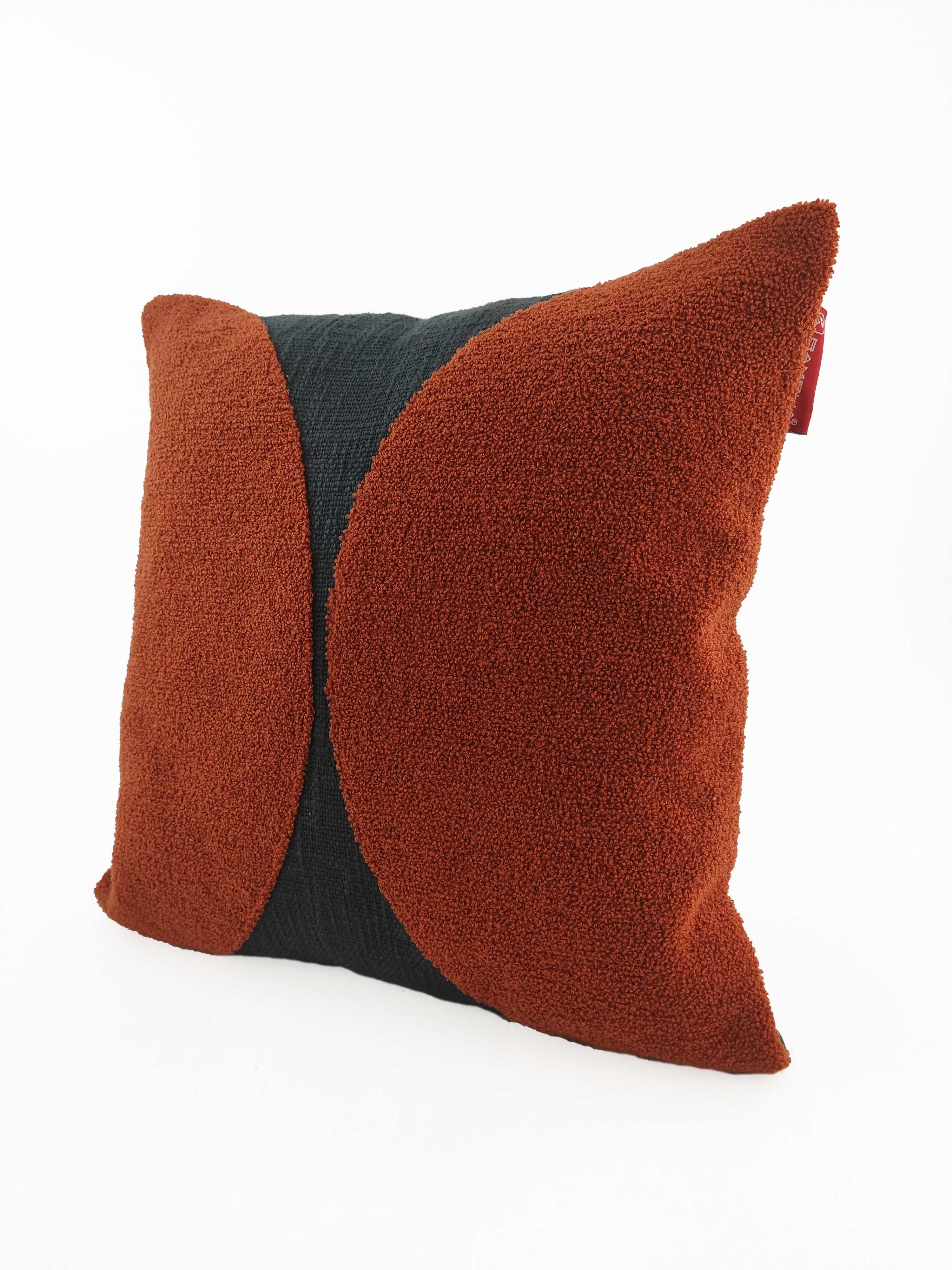The RAMSHA HOME Rust Color Cushion CS-121 features a textured cotton-polyester cover with two rust-colored curved sections on each side and a black central panel, ideal for enhancing your décor against a white background.