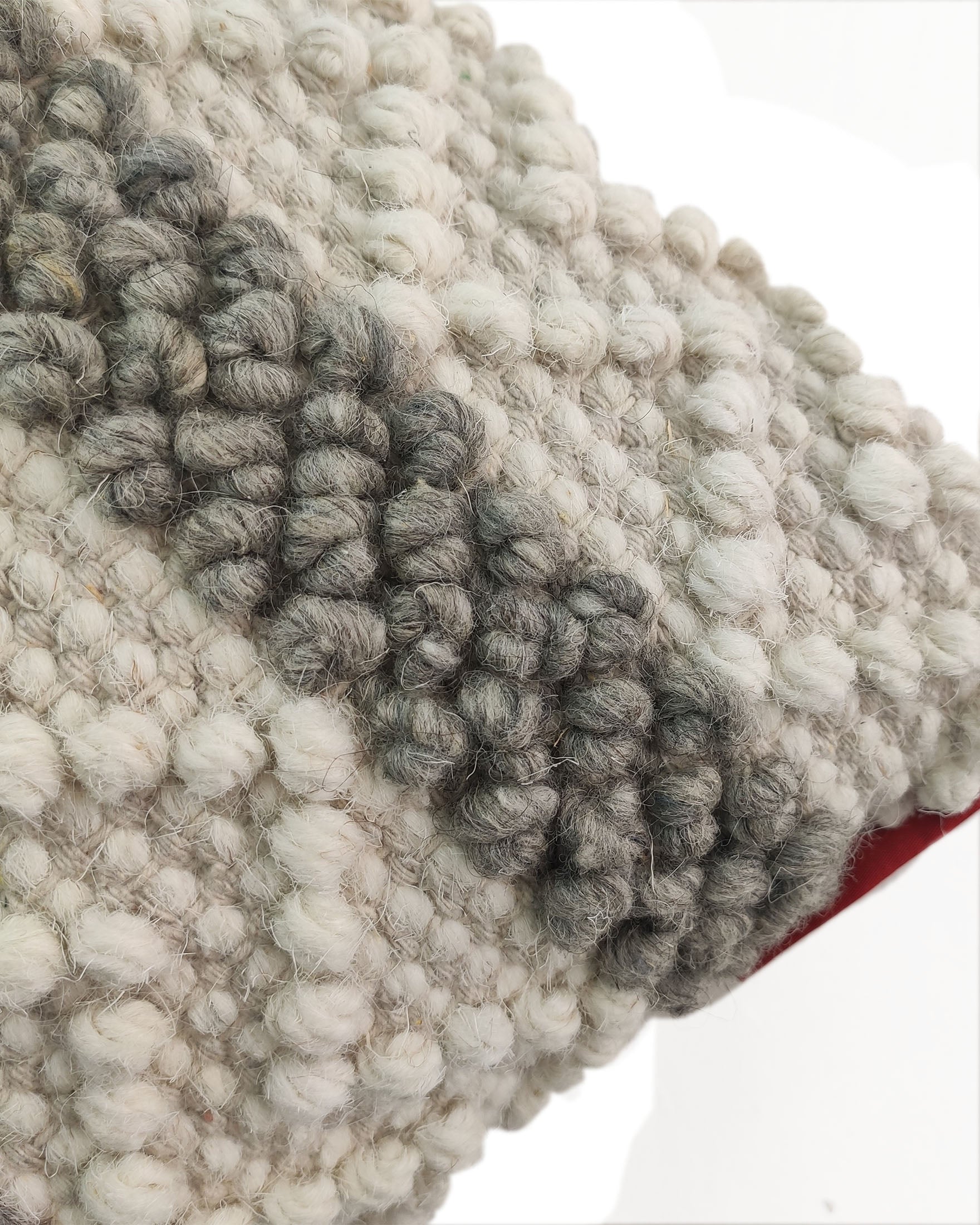 Close-up of the textured, handwoven surface of the RAMSHA HOME Embroidery Woven Cushion With Insert cs-161, featuring thick, looped yarn in cream, gray, and white; a hint of red backing appears at the bottom right.