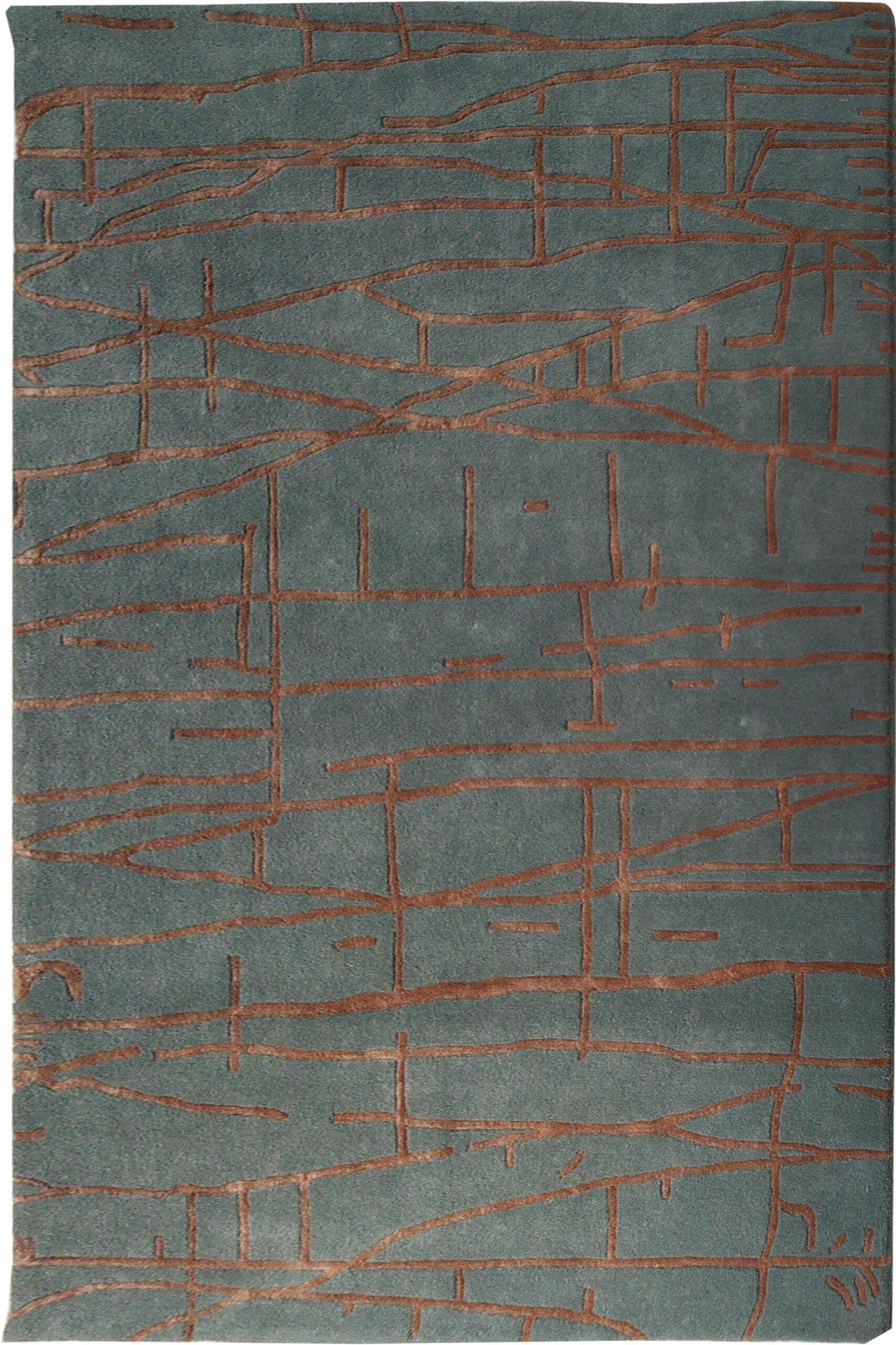 The RAMSHA HOME Abstract Rust Line Grid Teal Rug (HTWV-31, 180x270 CM) features a textured surface with a muted green base and abstract reddish-brown intersecting lines and shapes, creating a geometric pattern reminiscent of hand-tufted rugs.