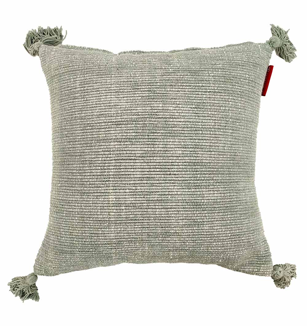 The RAMSHA HOME Cotton Cushion With Fringes CS-133 is a square, light gray cotton cushion with a subtle striped texture, corner fringes, high-quality filler for comfort, and a small red tag on the right side.