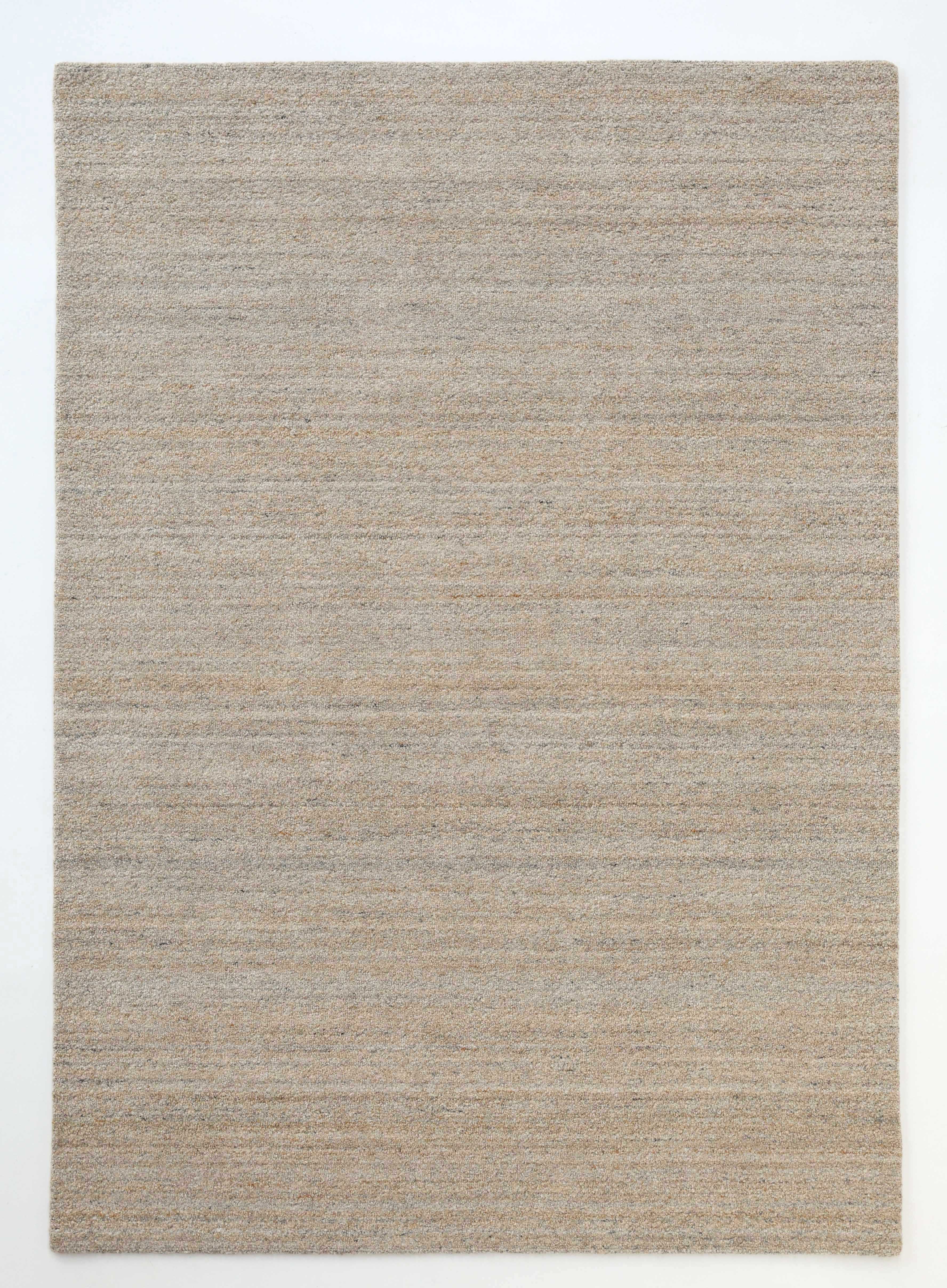 The RAMSHA HOME Handmade Natural Wool Rug – Textured Beige Area Rug (HTP 25) is a rectangular, minimalist rug in neutral beige and light brown tones with a simple textured finish and no visible patterns, displayed on a plain white background.