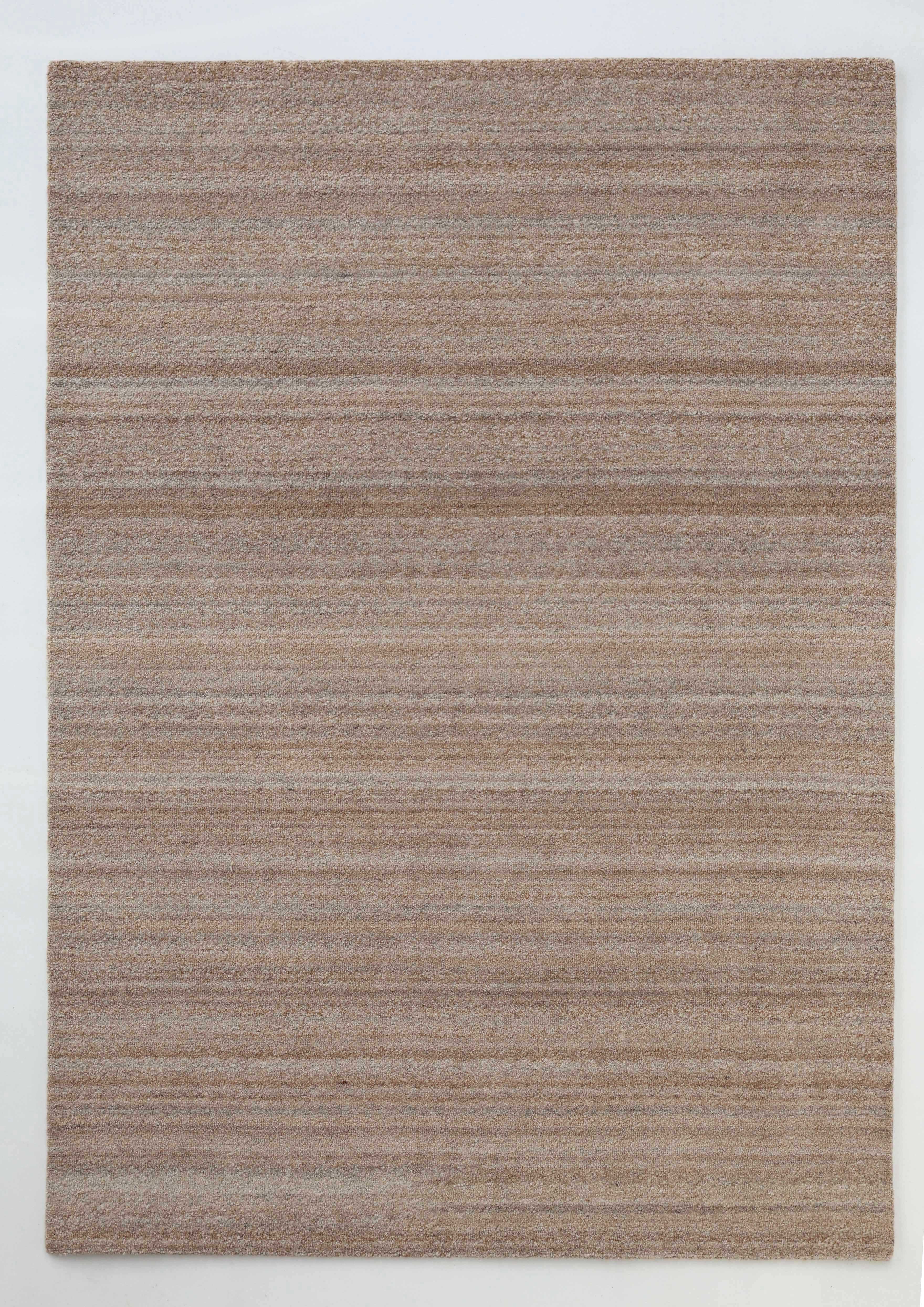 The RAMSHA HOME Handmade Natural Wool Rug – Textured Beige Area Rug (HTP 27) features subtle stripes in beige and light brown tones, offering a minimalist and elegant touch when laid flat on a light surface.