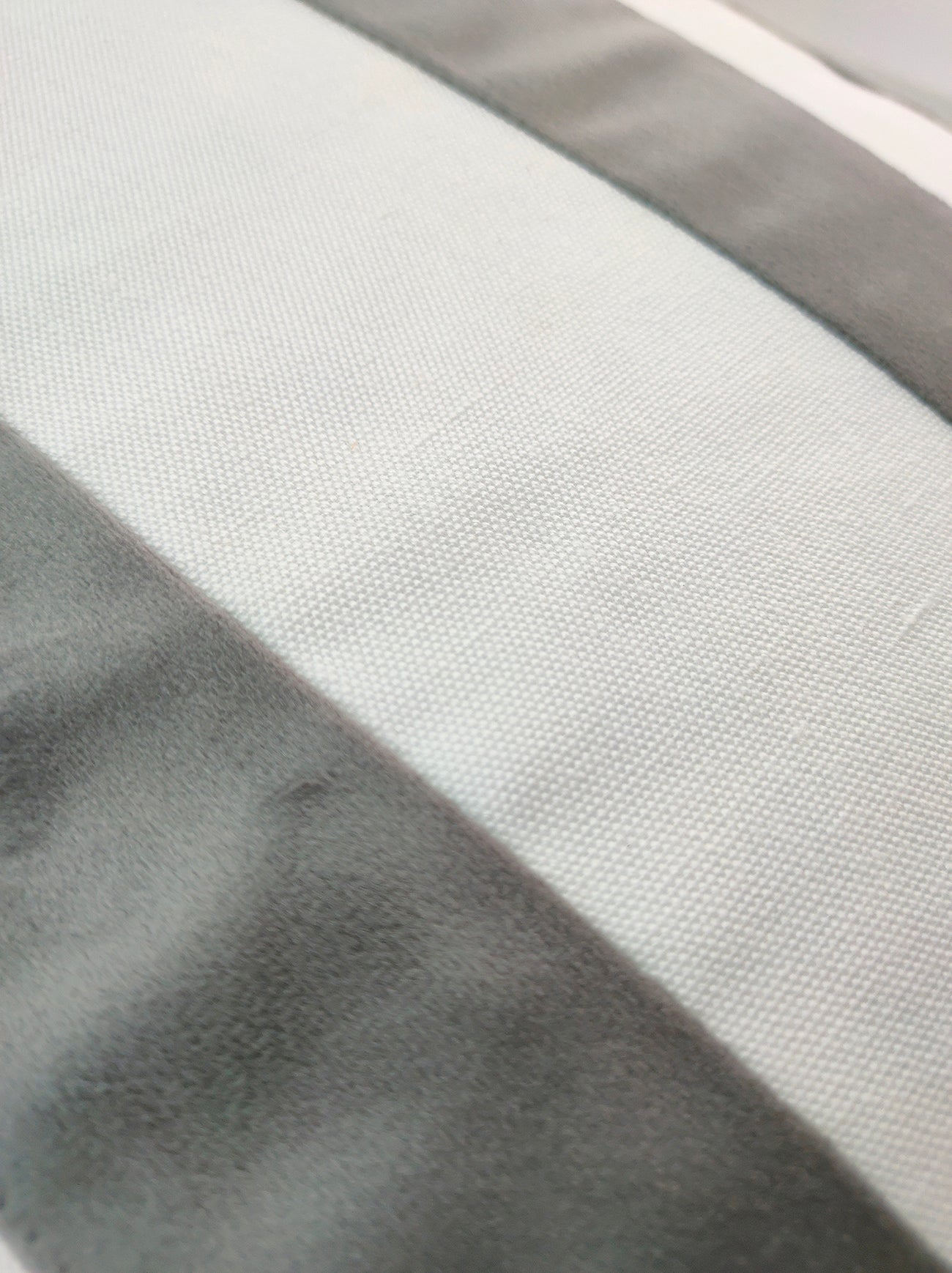 Close-up of RAMSHA HOME's CS-139 White & Grey Cushion shows its premium polyester surface with wide gray and off-white stripes, highlighting the modern texture and weave.