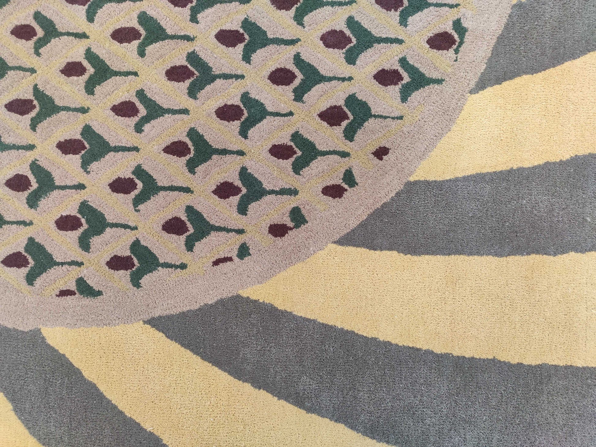 The RAMSHA HOME Modern Mustard & Grey Wool Carpet (202x292 cm, HTW-30) features a hand-tufted design with green and maroon geometric shapes on beige, bordered by mustard and grey stripes—an elegant, modern area rug for any space.