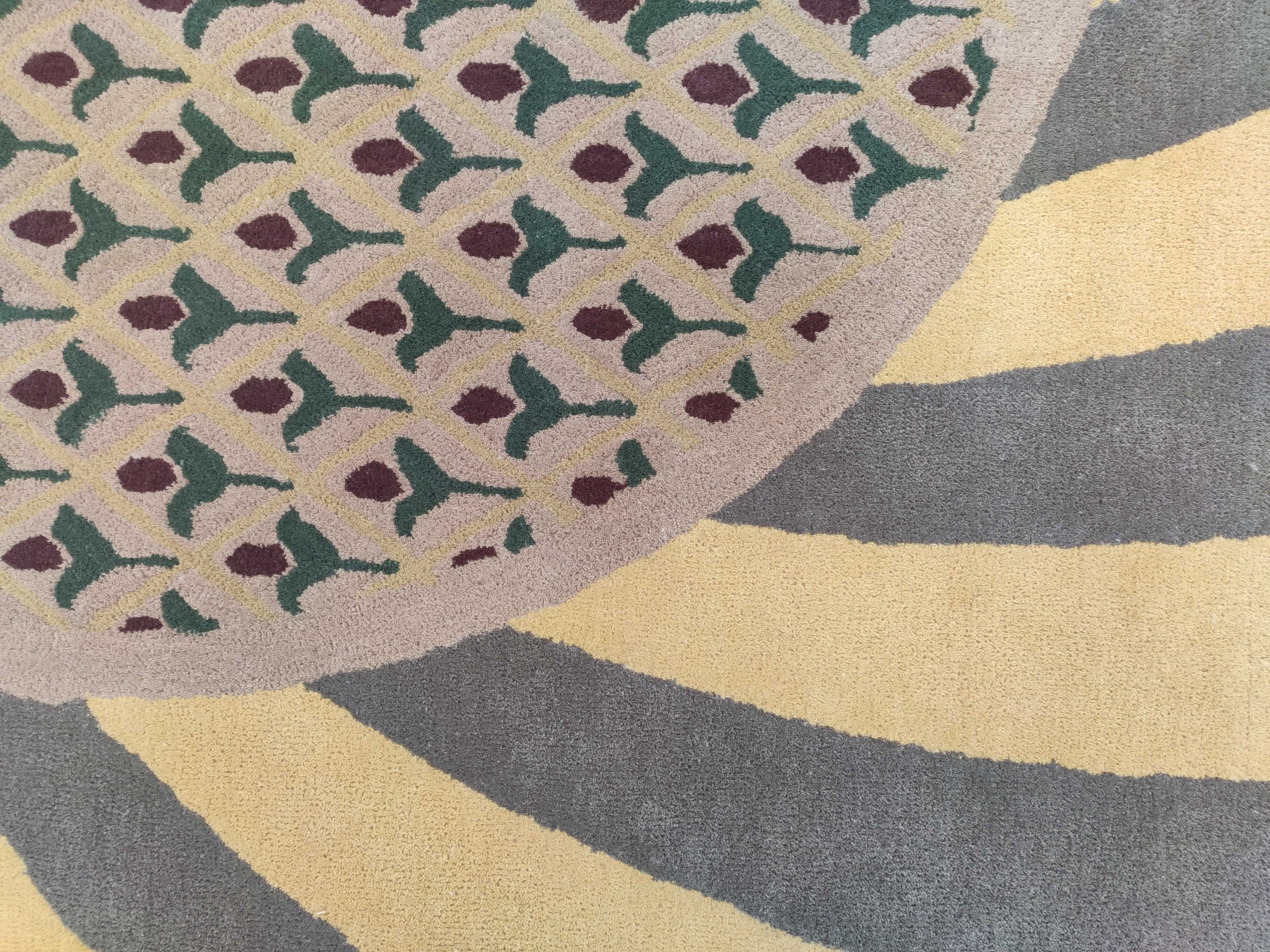 The RAMSHA HOME Modern Mustard & Grey Wool Carpet (202x292 cm, HTW-30) features a hand-tufted design with green and maroon geometric shapes on beige, bordered by mustard and grey stripes—an elegant, modern area rug for any space.