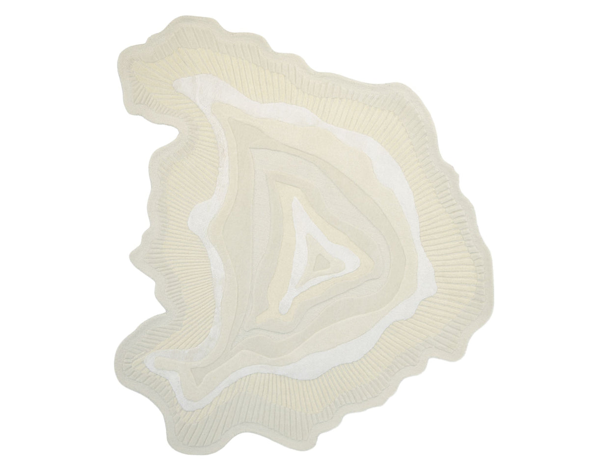 The Natural Handmade Area Rug - HTWV-126 by RAMSHA HOME features an abstract, irregular shape in cream and beige tones, with sculpted, wavy concentric patterns inspired by geological strata or a topographic map. Handcrafted from a neutral wool blend, this area rug provides both visual and textural interest—perfect for enhancing any modern space.