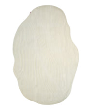 The Hand Tufted Multi Color Decor Rug HTWV-101 by RAMSHA HOME features a cream-colored, irregular shape and wavy, textured lines, making it a modern accent rug that adds a unique and stylish touch to any space.