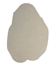 The RAMSHA HOME Beige Color Shape Handmade Rug HTW 104 features an irregular shape and a beige hue, with a textured, scale-like pattern across its surface. This modern rug is displayed against a white background.