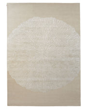 The RAMSHA HOME Hand-Tufted Carpet For Home Decor HTWV-76 is a contemporary beige area rug showcasing a striking white radial pattern reminiscent of tree rings or a sunburst at its center. Set against a light background, this elegant wool floor covering effortlessly blends modern design with timeless sophistication, making it a neutral yet eye-catching addition to any space.