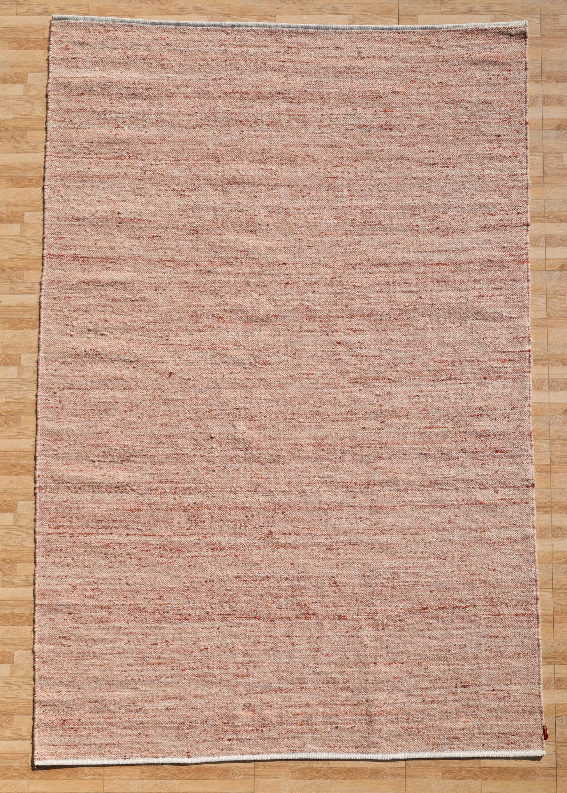 The RAMSHA HOME Dusty Rose Artisan Flatweave Wool Rug (SRN-042) features a large rectangular handmade design in beige and light red, with textured weaving that highlights traditional craftsmanship and a neutral colorway.