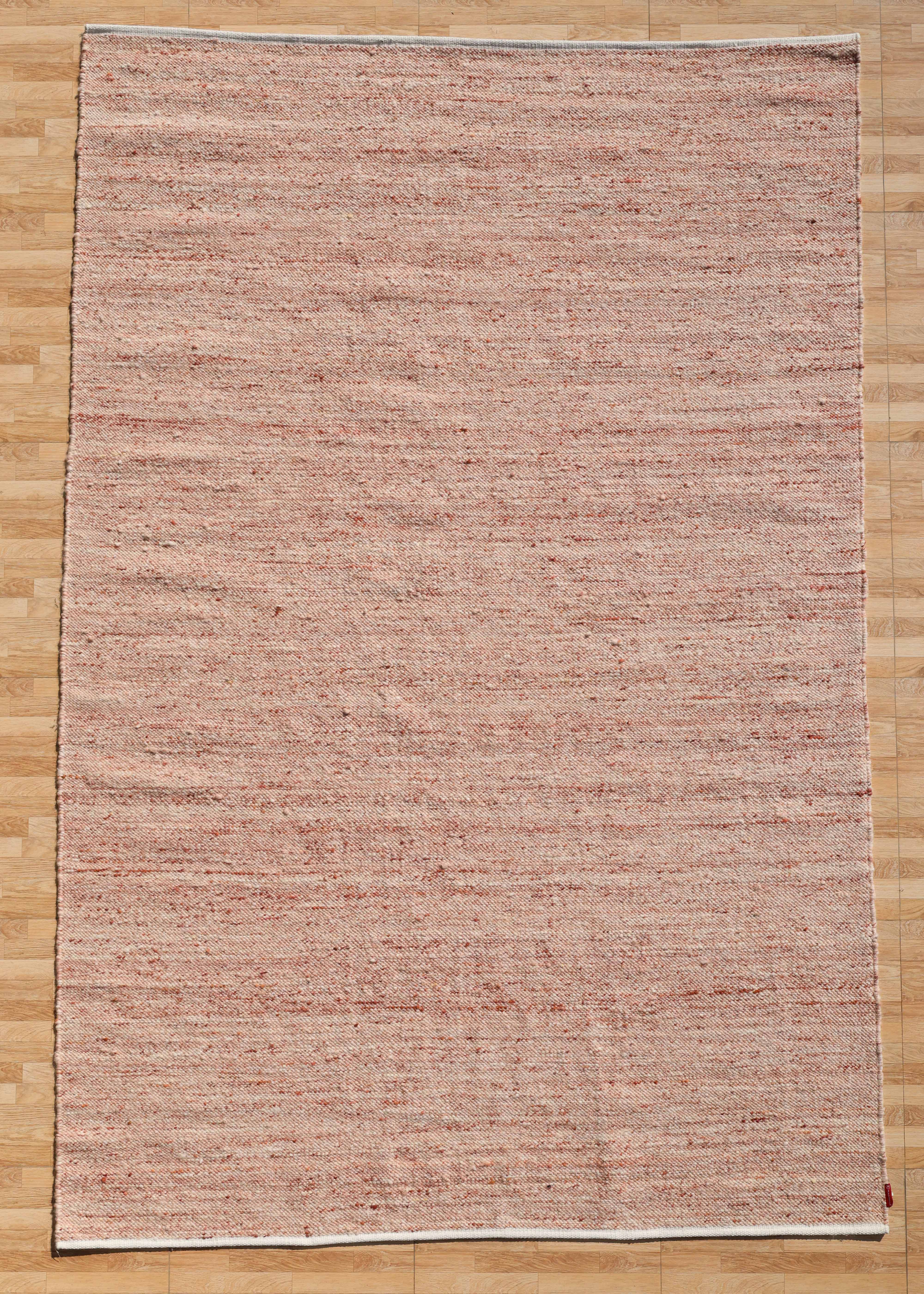 The RAMSHA HOME Dusty Rose Artisan Flatweave Wool Rug (SRN-042) features a large rectangular handmade design in beige and light red, with textured weaving that highlights traditional craftsmanship and a neutral colorway.