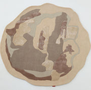 The RAMSHA HOME Round Abstract Shaped Rug (HTWV-193) features a textured contour pattern in beige, brown, and taupe, adding modern flair to any space. Displayed on a plain white background.