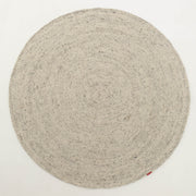 A handmade, round beige braided wool area rug by RAMSHA HOME (model BR 100) featuring a subtle spiral pattern is displayed on a white background, with a small red tag attached to the edge.