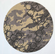 The RAMSHA HOME Modern Geometric Round Rug CMN 133 showcases a beige and gray camouflage pattern with a black hexagonal design—ideal as a modern abstract accent for stylish spaces.